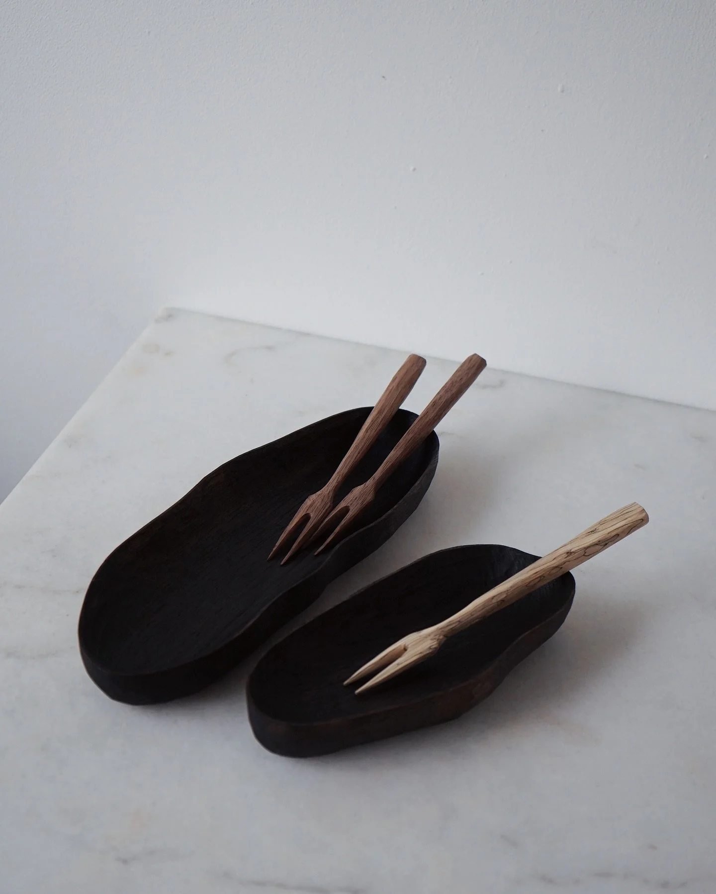 Plates paired with pickle forks. Ebonised sweet chestnut, walnut and spalted hornbeam. 

Softly textured with chisel and knife 

I had planned on making a few more of these but for now I only have 2! 
If you like them, they are available tomorrow at 
