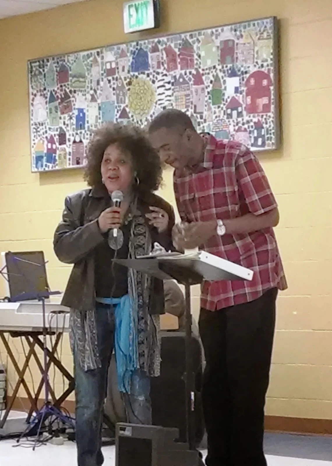 Anthony Pressley and Karen Griner-Smith (also a published poet who read that night, and grandmother to Amir), accompanied by Roger Murray on keyboards, concluded the evening by leading everyone in a group singing of Lean on Me.
