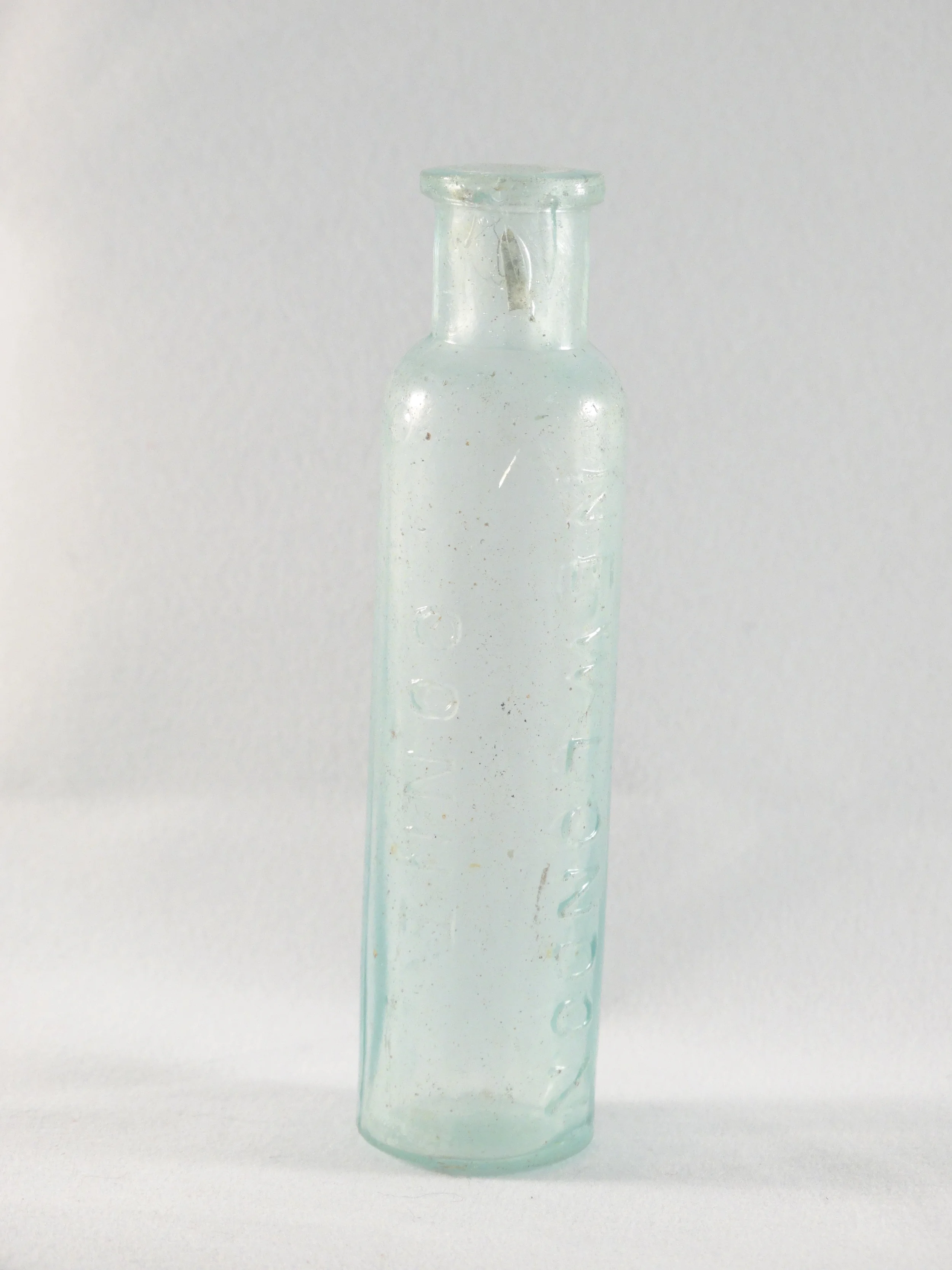 small, narrow blue bottle