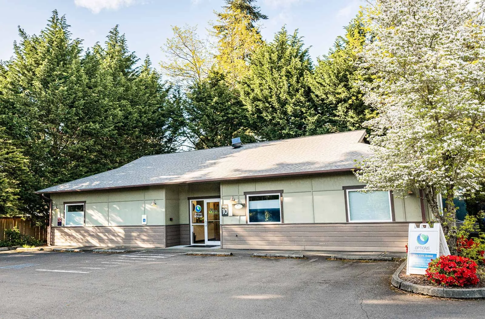 Exterior of a professional counseling office in Olympia, Washington surrounded by trees