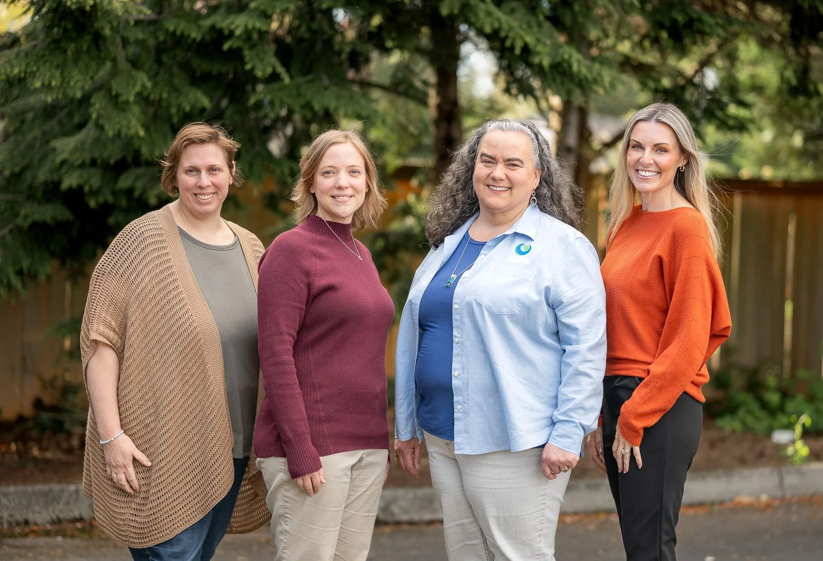 Four staff members photographed together outside their Olympia office