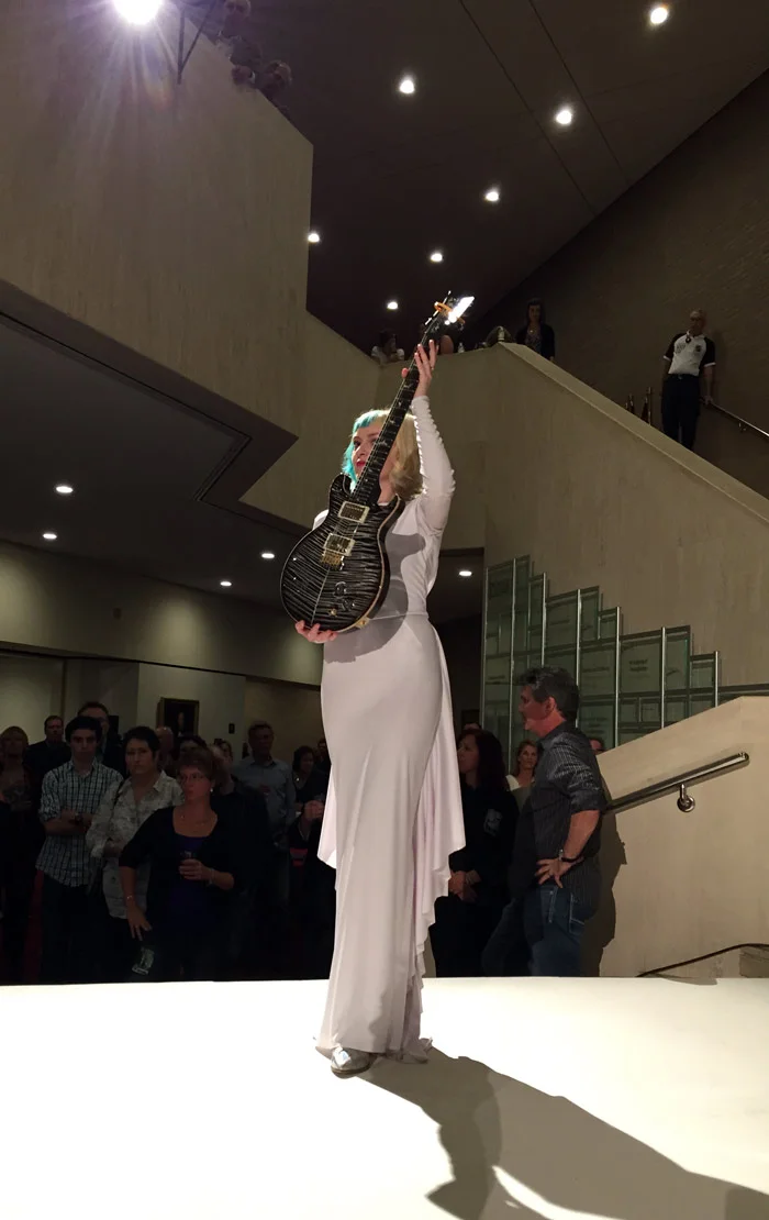 Sarah lifts a stunning guitar signed by Carlos Santana.