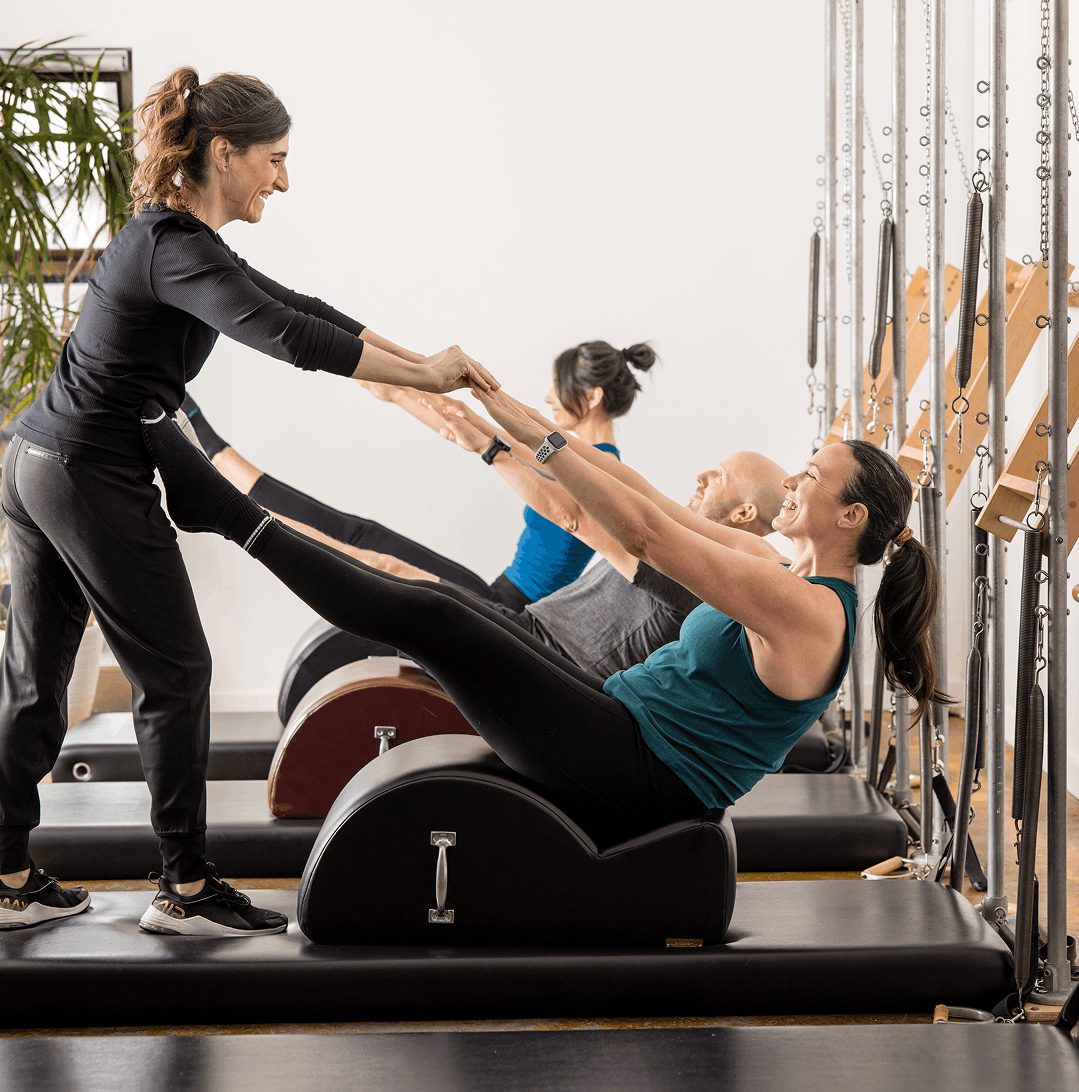 a woman in a tower pilates class in seattle at union pilates