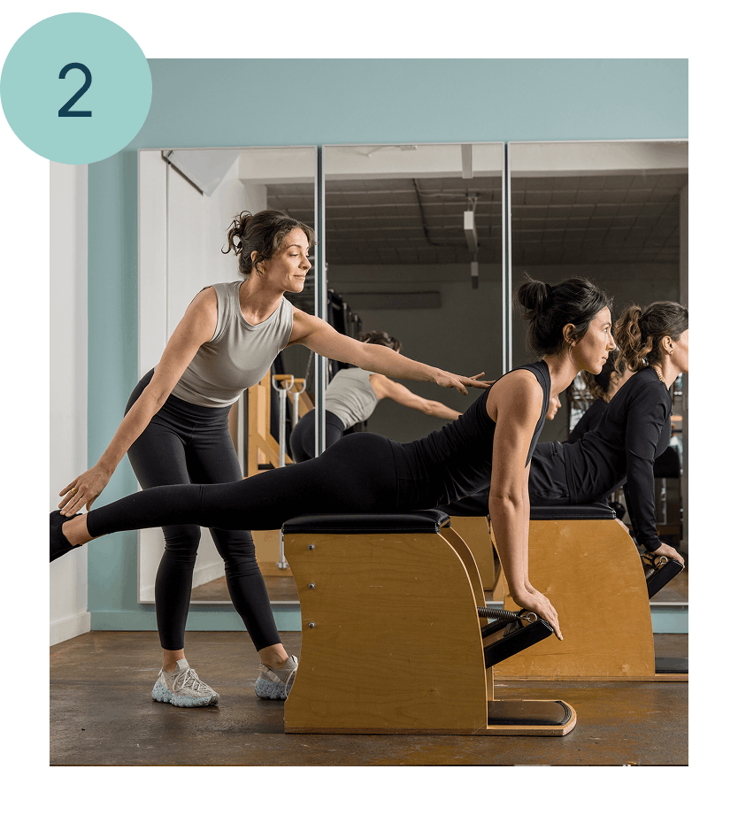 a woman teaching another woman pilates for after birth in seattle
