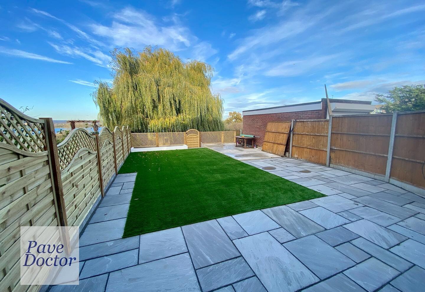 A lovely view across the reservoir from this garden. We used natural grey Indian sandstone slabs, new Neris fence panels, artificial grass and a concrete base ready for a new summer house/ office room to be installed.

#PaveDoctor
#chingford
#patio
#