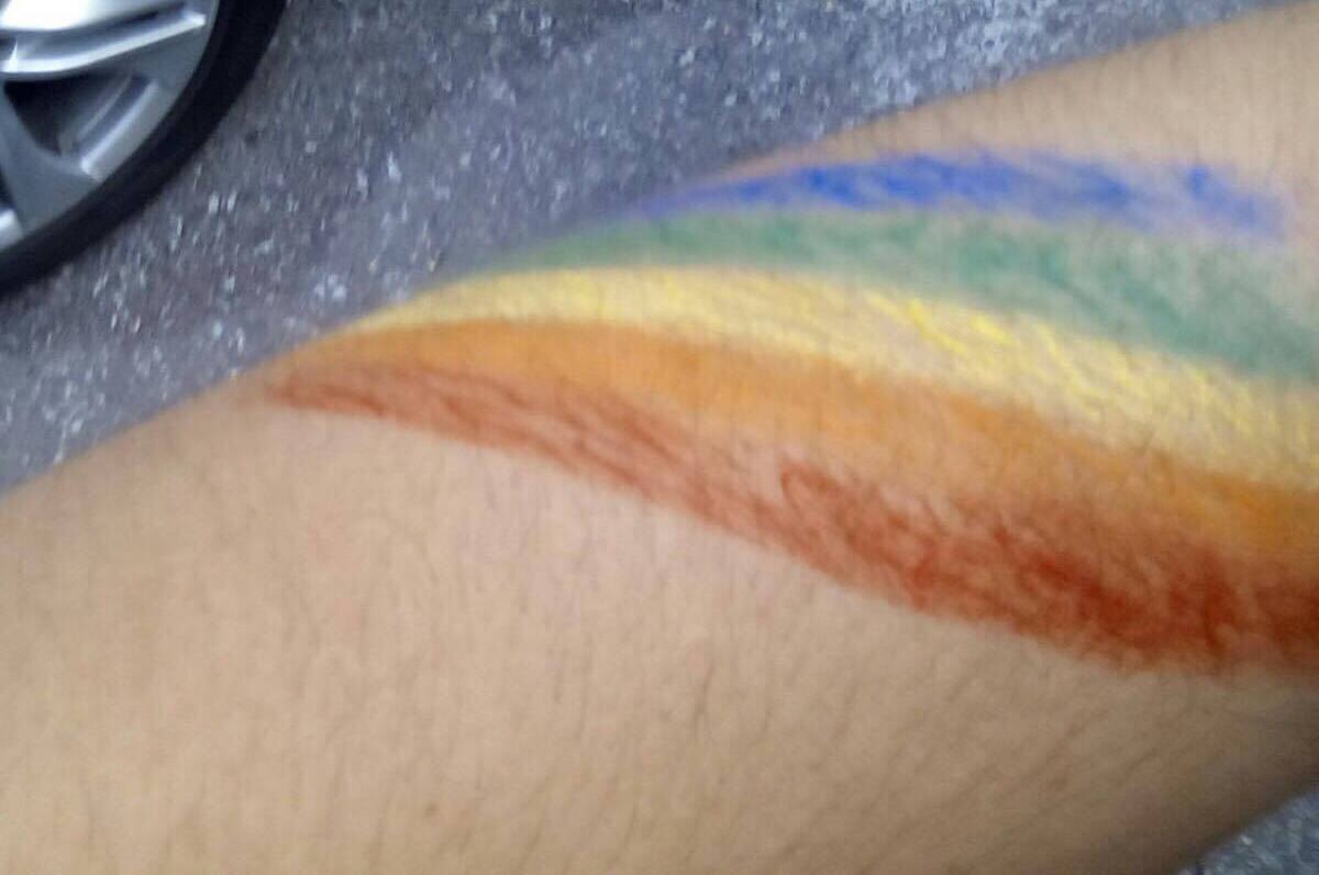 For his own Safety, Omar cannot show his face. Here, he sports his Rainbow Body Art. 