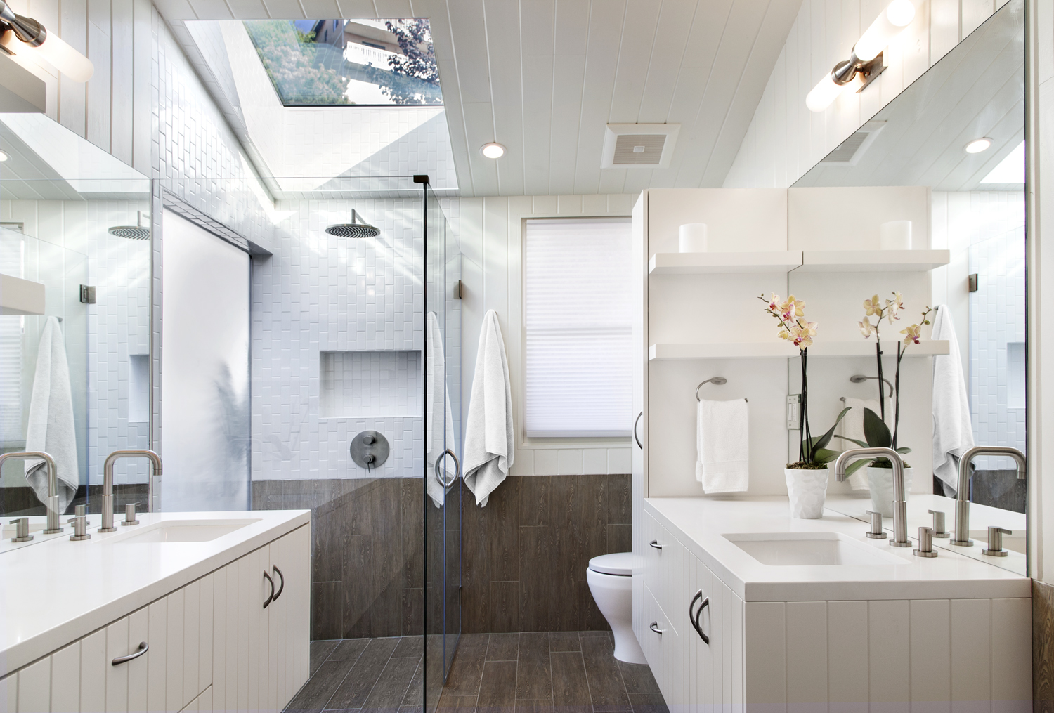 His and Her separate vanities, each with drawers and a tall cabinet for linens. Note the clean lines around the glass, mirrors and cabinets. Detail is very important in all of our projects.