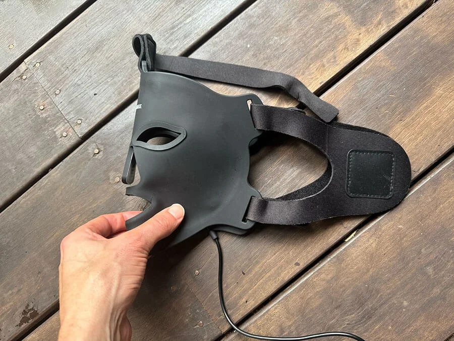 bon charge the best red light therapy mask folded in half to show the u straps on a table