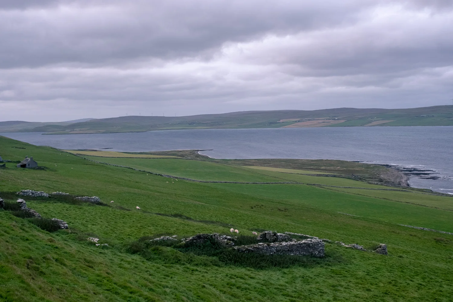 Rousay, view from 5500 year old tomb, across a ruined highland clearances home to the passage whose current wouldn’t allow us to traverse it