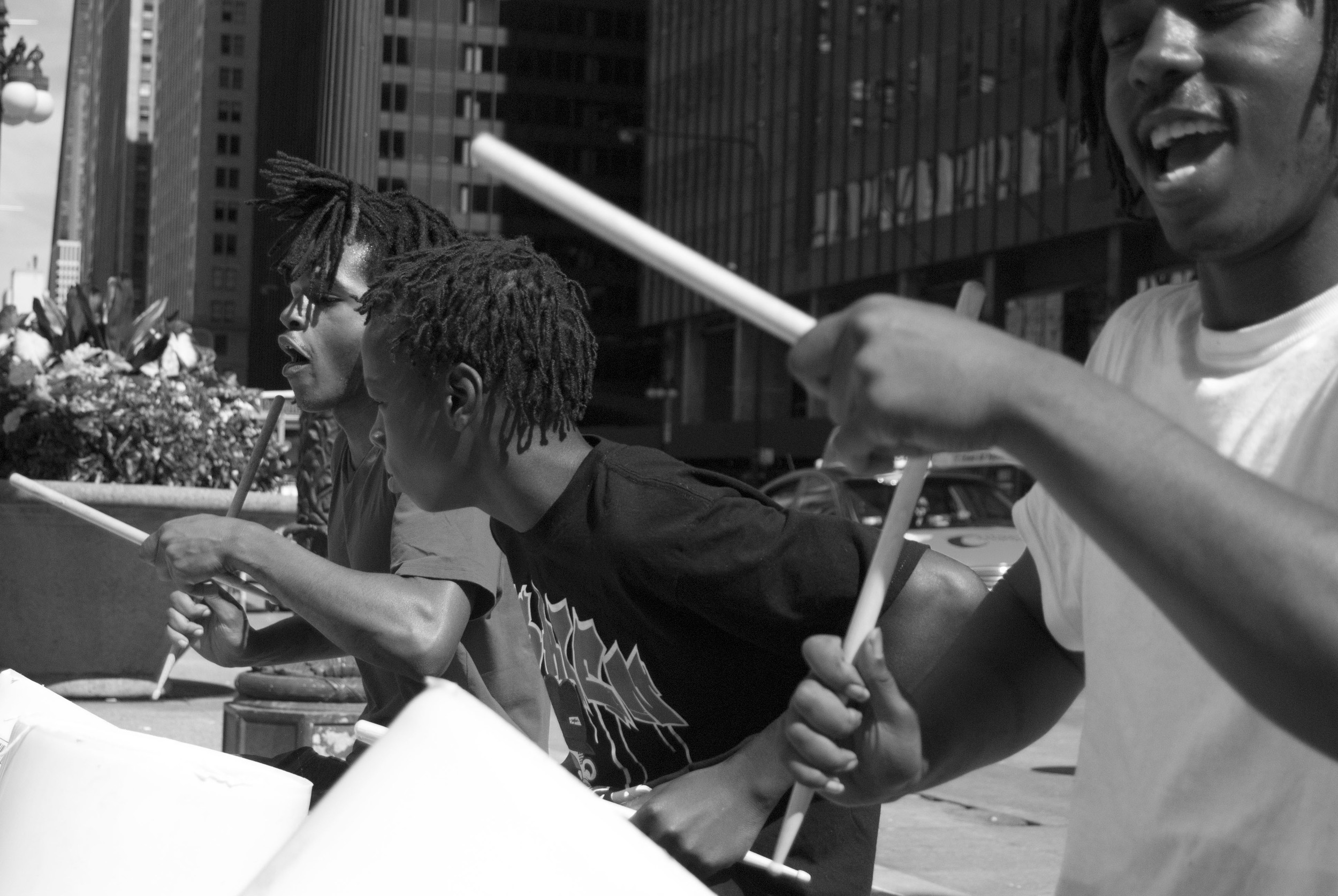  Three boys play drums on plastic buckets in downtown Chicago in September 2013. 