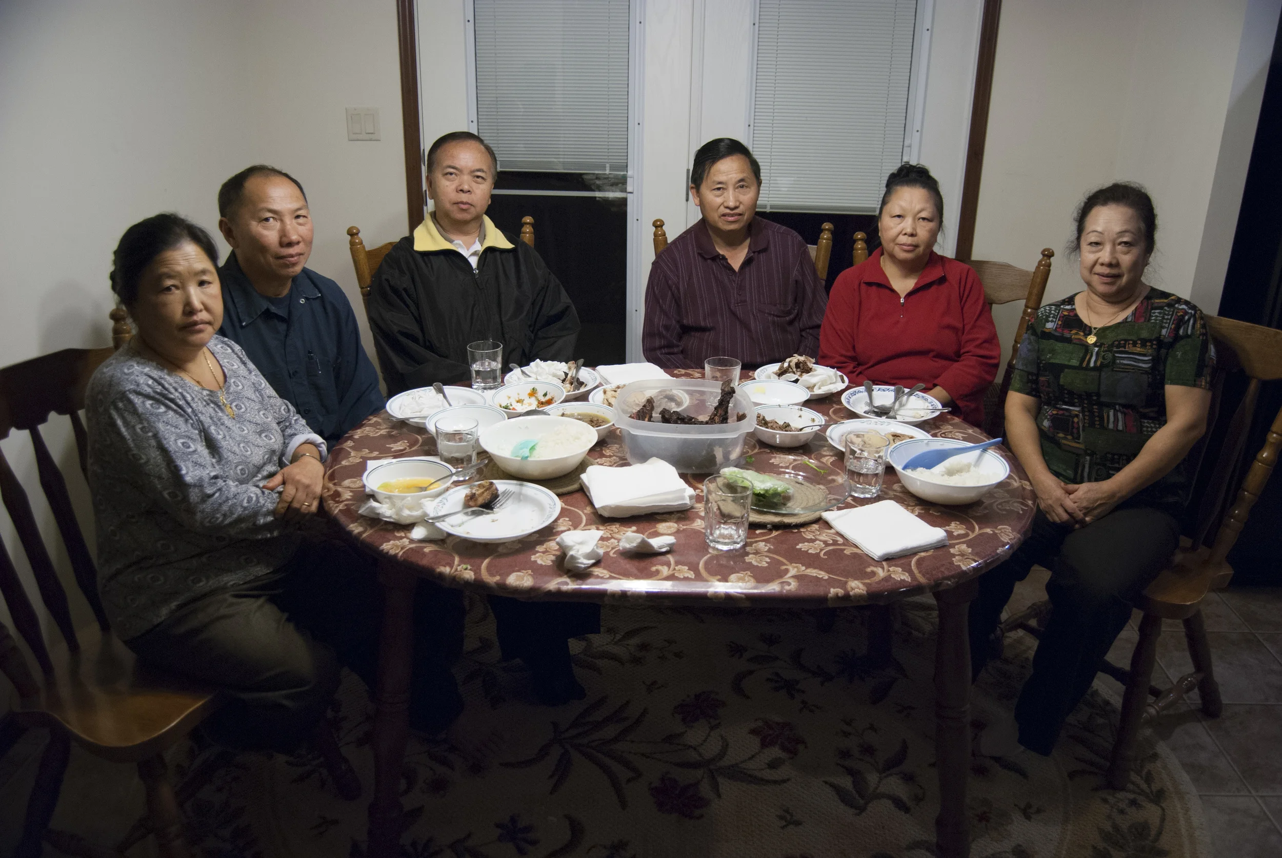  Marinated and bon-fire cooked dear lays in the middle of the table surrounded by white rice, cucumber soup, and spring rolls. The rice and vegetables were gathered from the Yang's farm earlier that day. The women, Song, Eang Yang, and Mrs. Que (from