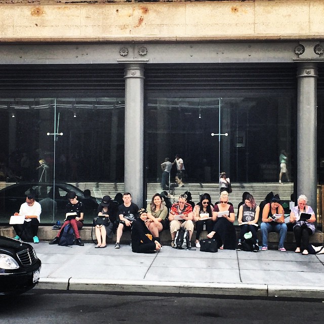 The students sketching outside the Whitney Museum while waiting to get inside. Kenneth is seated first person to the left in the photo.