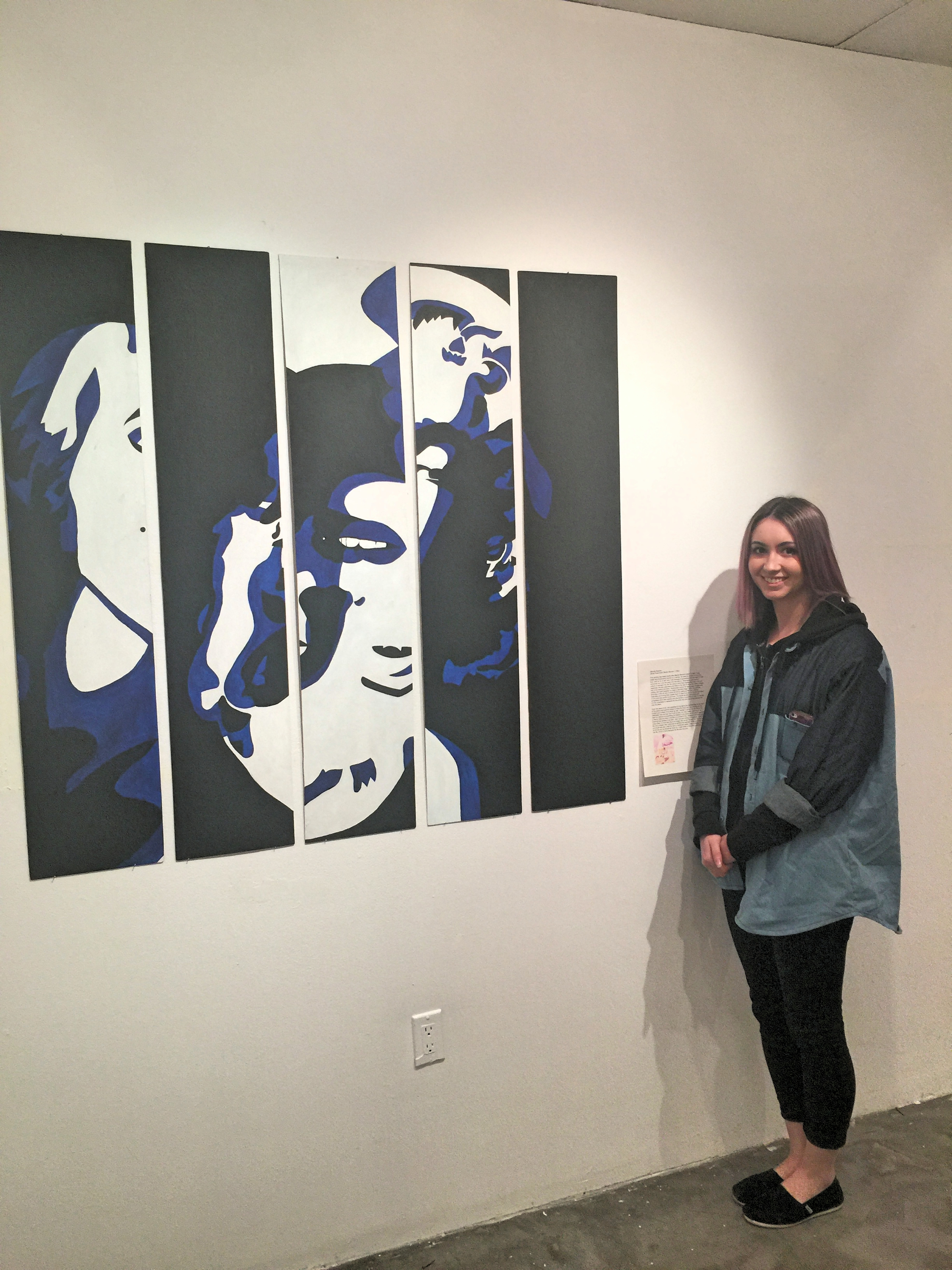 Michelle stands with her response art work to the Rosenquist piece she was assigned from MoMA.