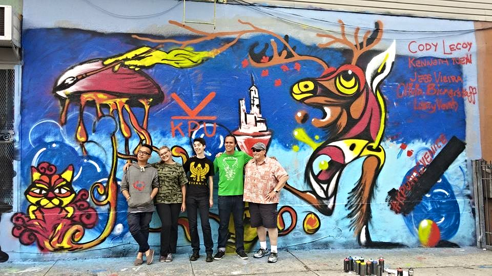 Kenneth, Olivia, Jess, Cody, and Larry pose proudly in front of their completed street art mural in Brooklyn. From what we hear, it is still there!