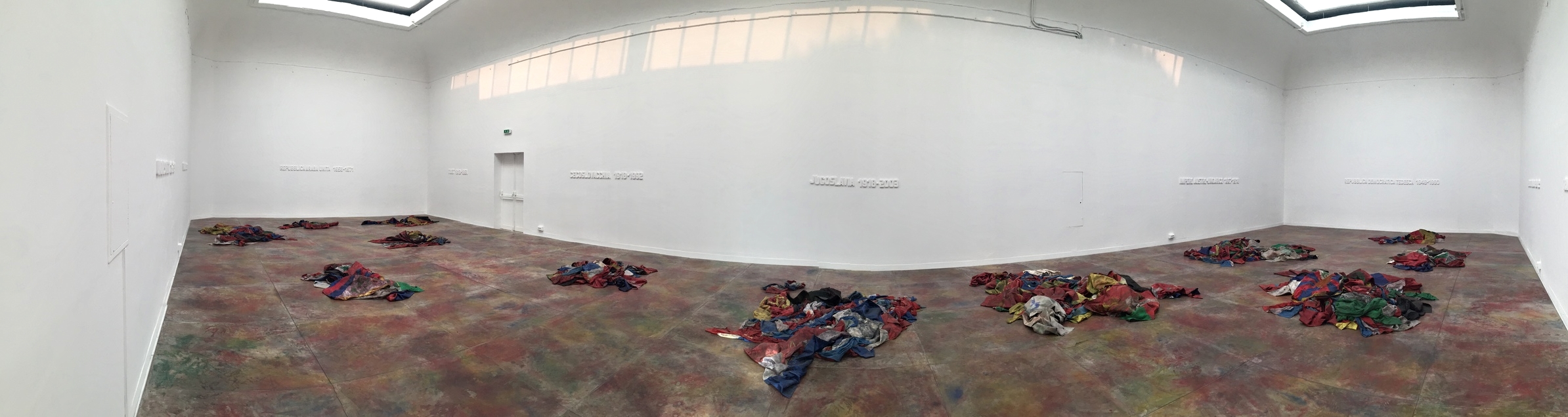 Inside the Serbian pavilion, the installation United Dead Nations by Ivan Grubanov explores the idea of "nation" by looking at the flags and banners of nations that no longer exist such as Yugoslavia, Czechoslovakia, and the Austro-Hungarian Empire. The colours all appear to merge and suggest an unexpected kind of unity.