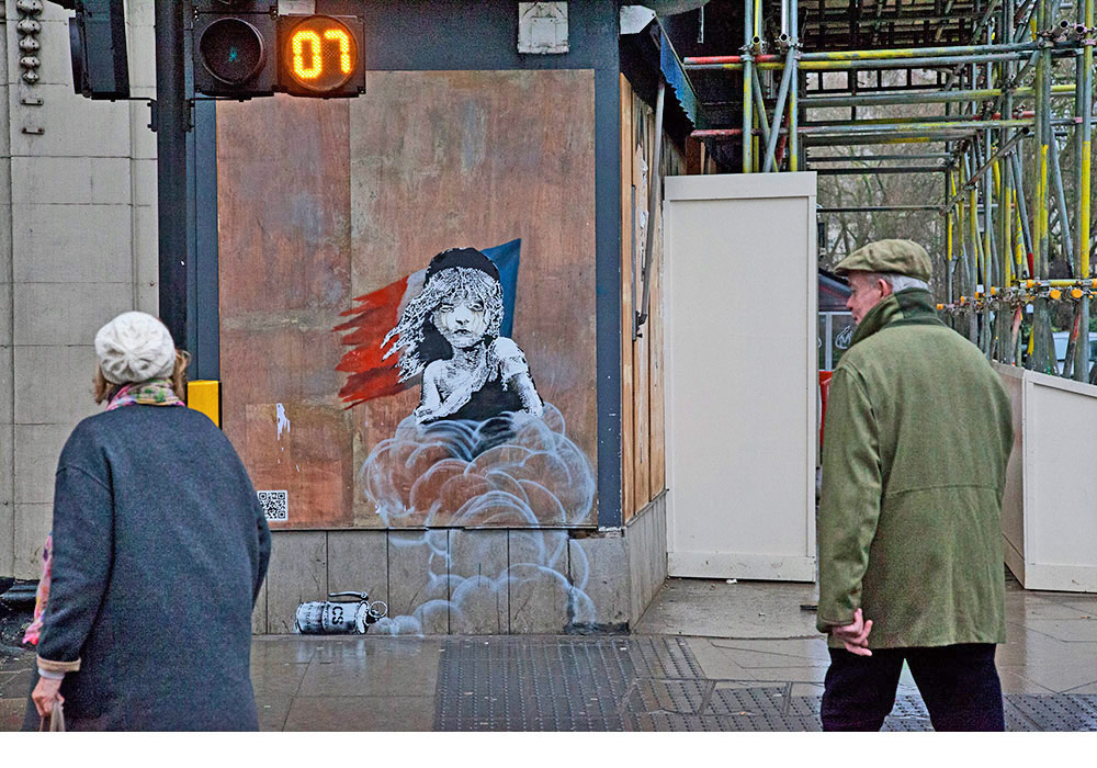 "Banksy's First Interactive Work Criticizes Police Violence Against Refugees"