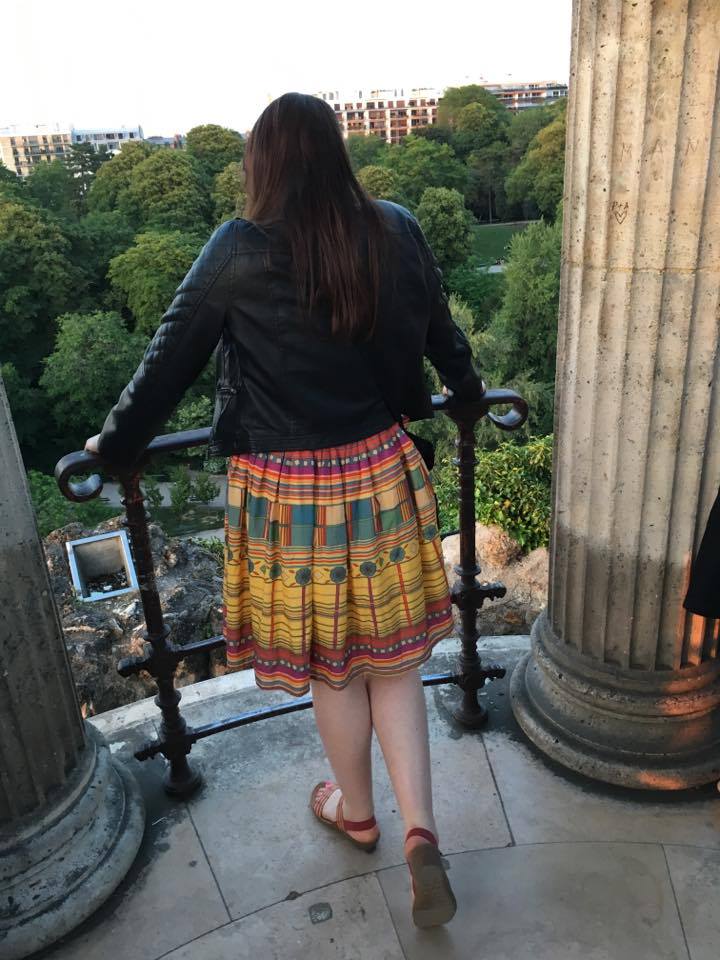 Josie looking out over a scene juxtaposing ancient and modern Paris.