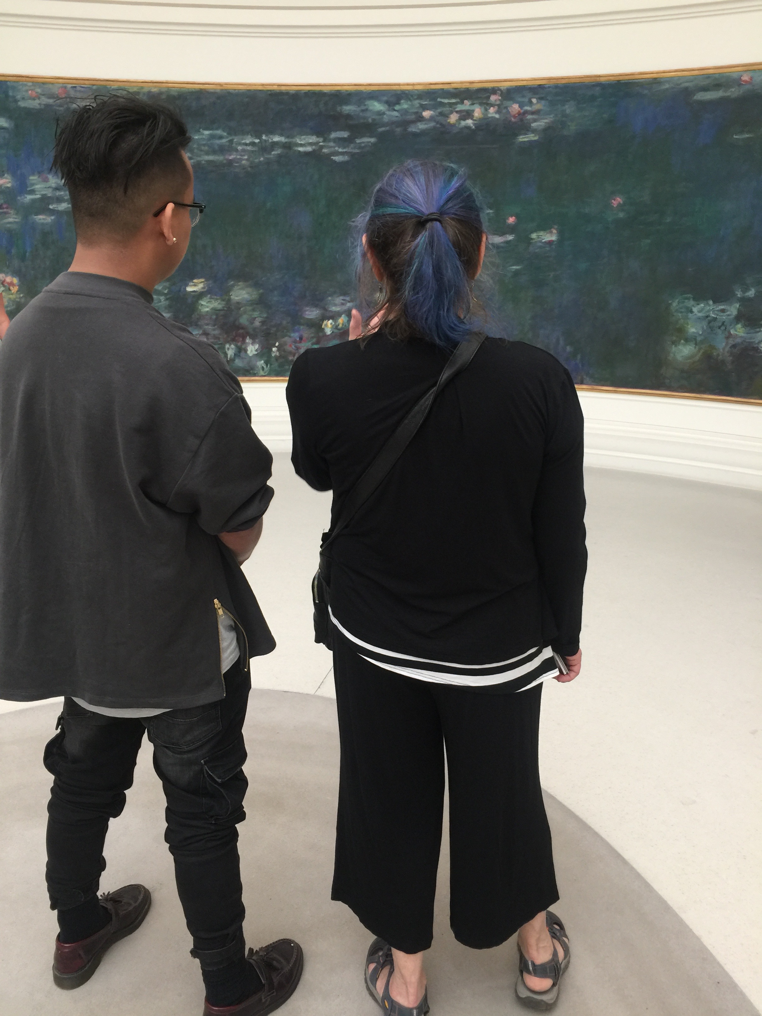 Elizabeth examining and discussing a Monet panel with field school student Kenneth.