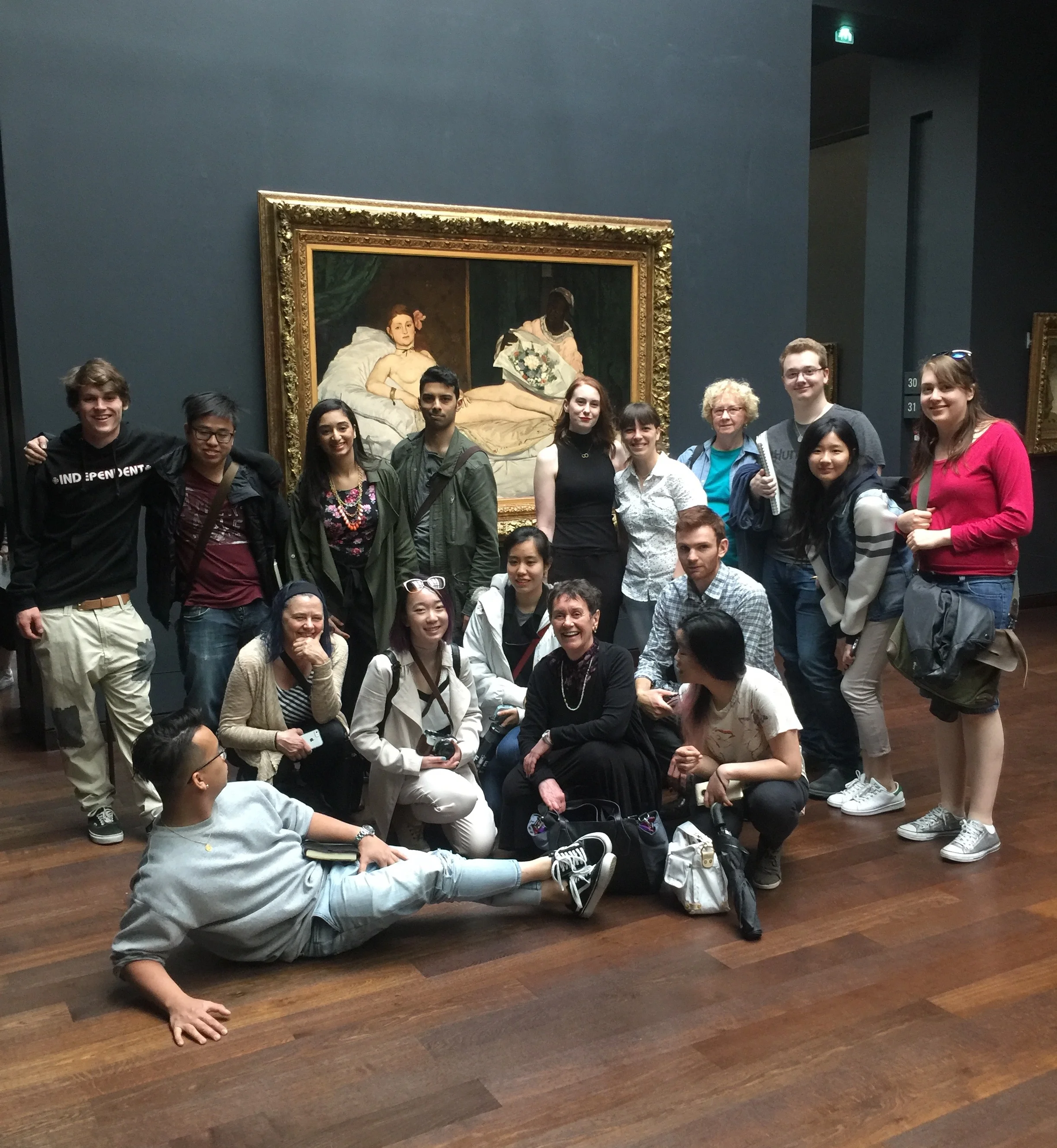 Elizabeth (first on left in second row) with the field school students, examining the iconic Olympia (1863) by Edouard Manet at the Orsay Museum.