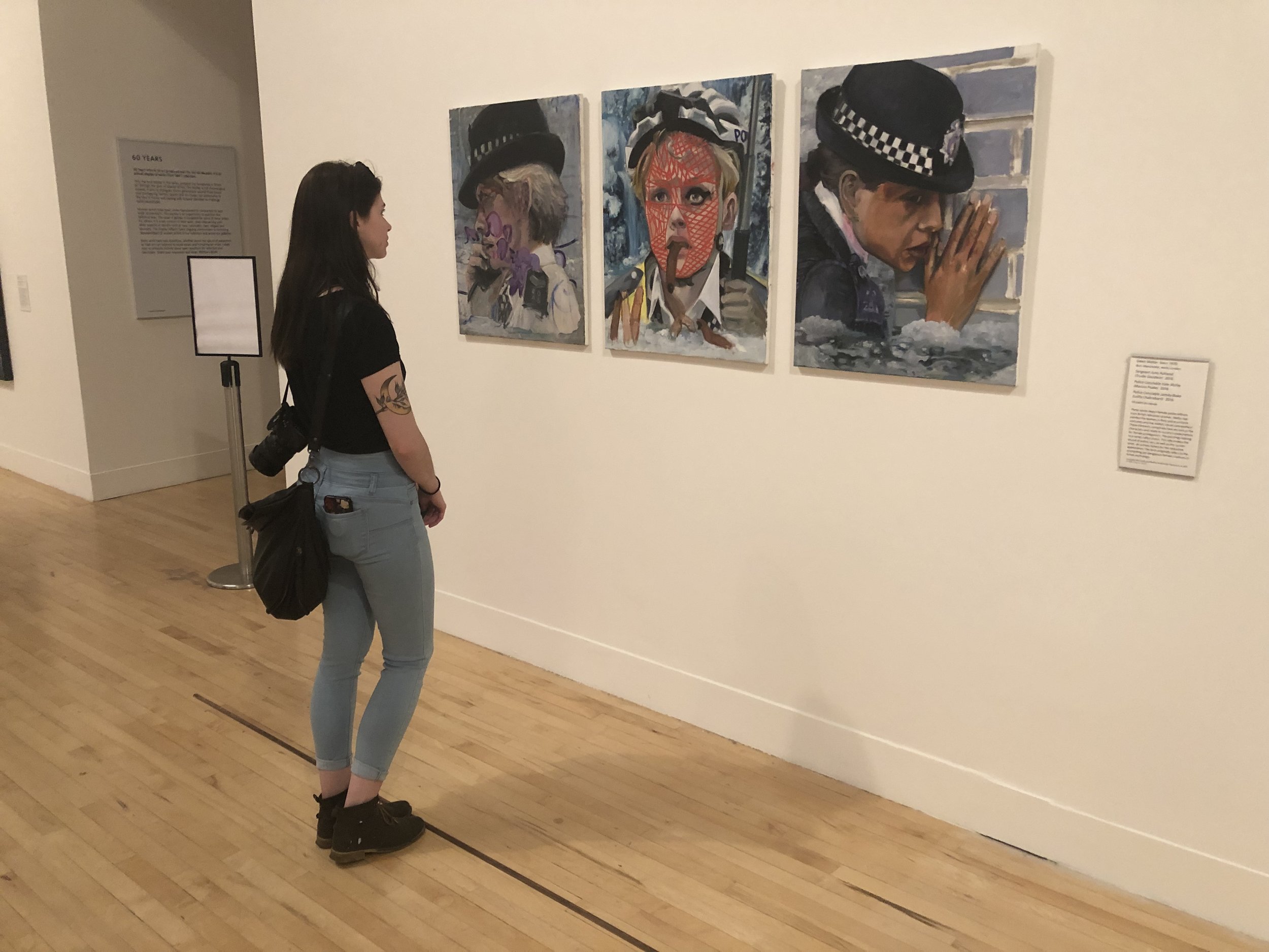 Meg looking at another of her assigned artists at Tate Britain— Dawn Mellor’s Police Constable Kate McFay (Maxine Peake) (2016)