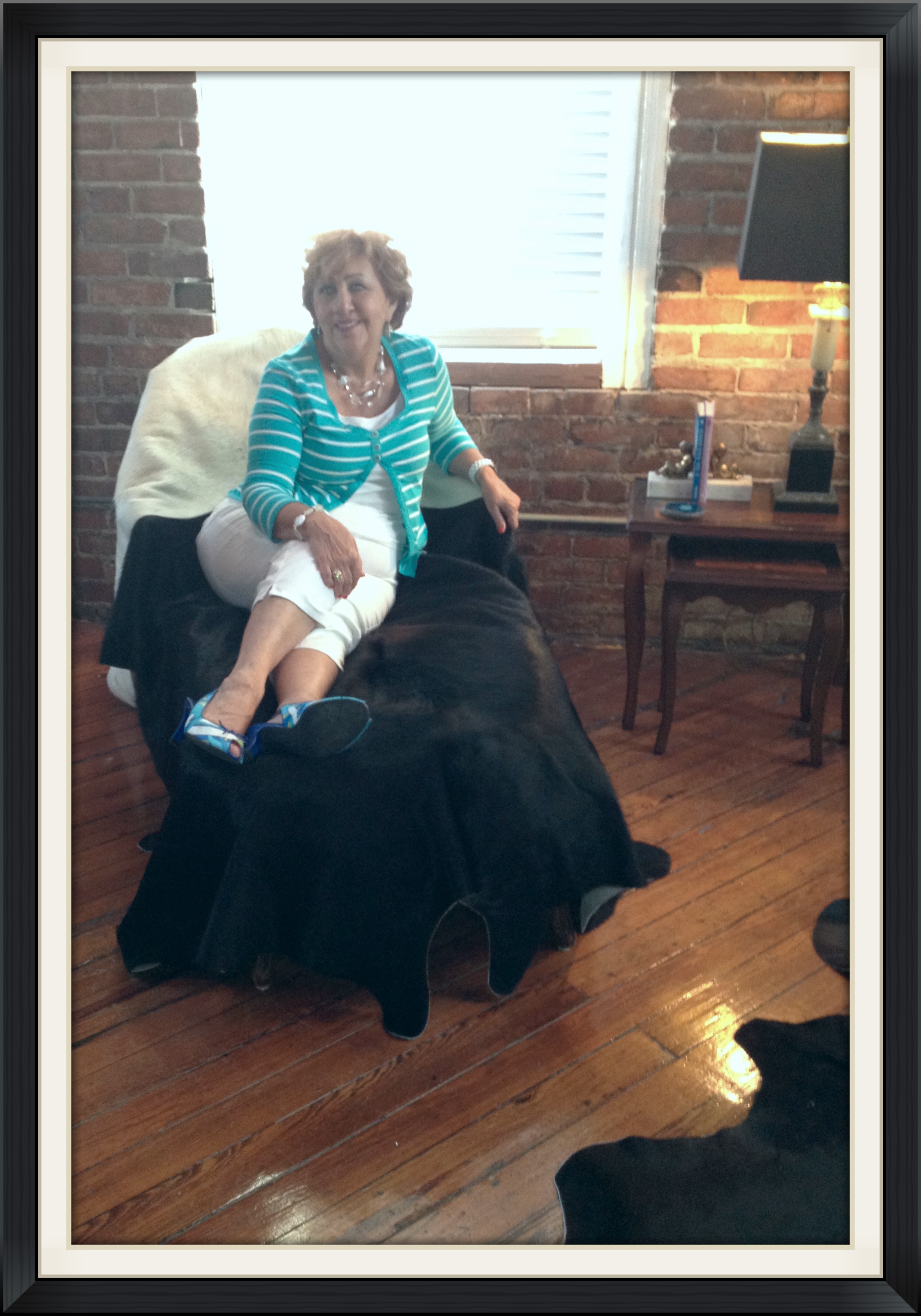 YBOR CHAMBER MEMBER ENJOYING THE COWHIDE CHAISE