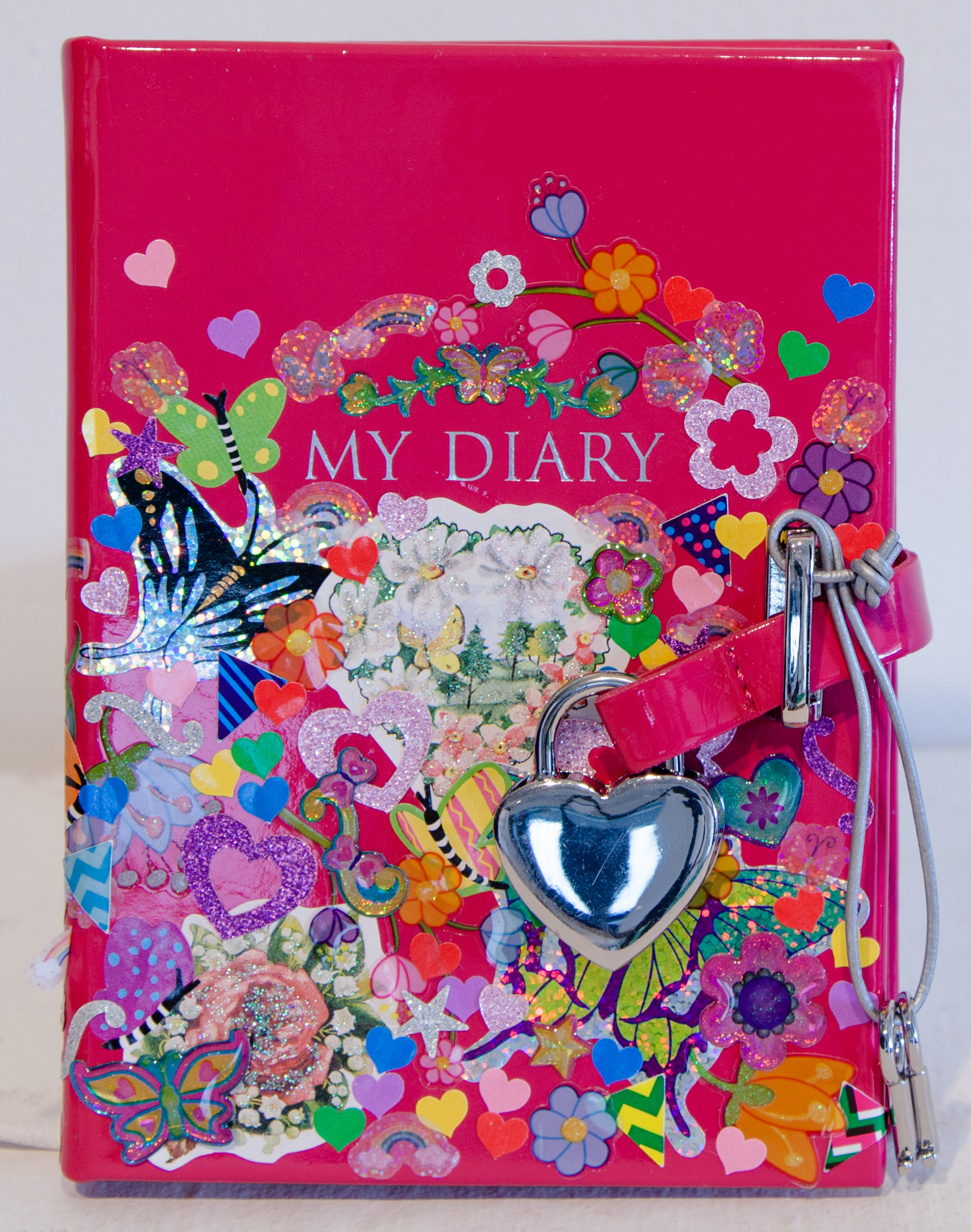    Felia (Diary, Front) ,  found patent leather pink diary, and sticker collage, 4" x 6" x 1", 2016 