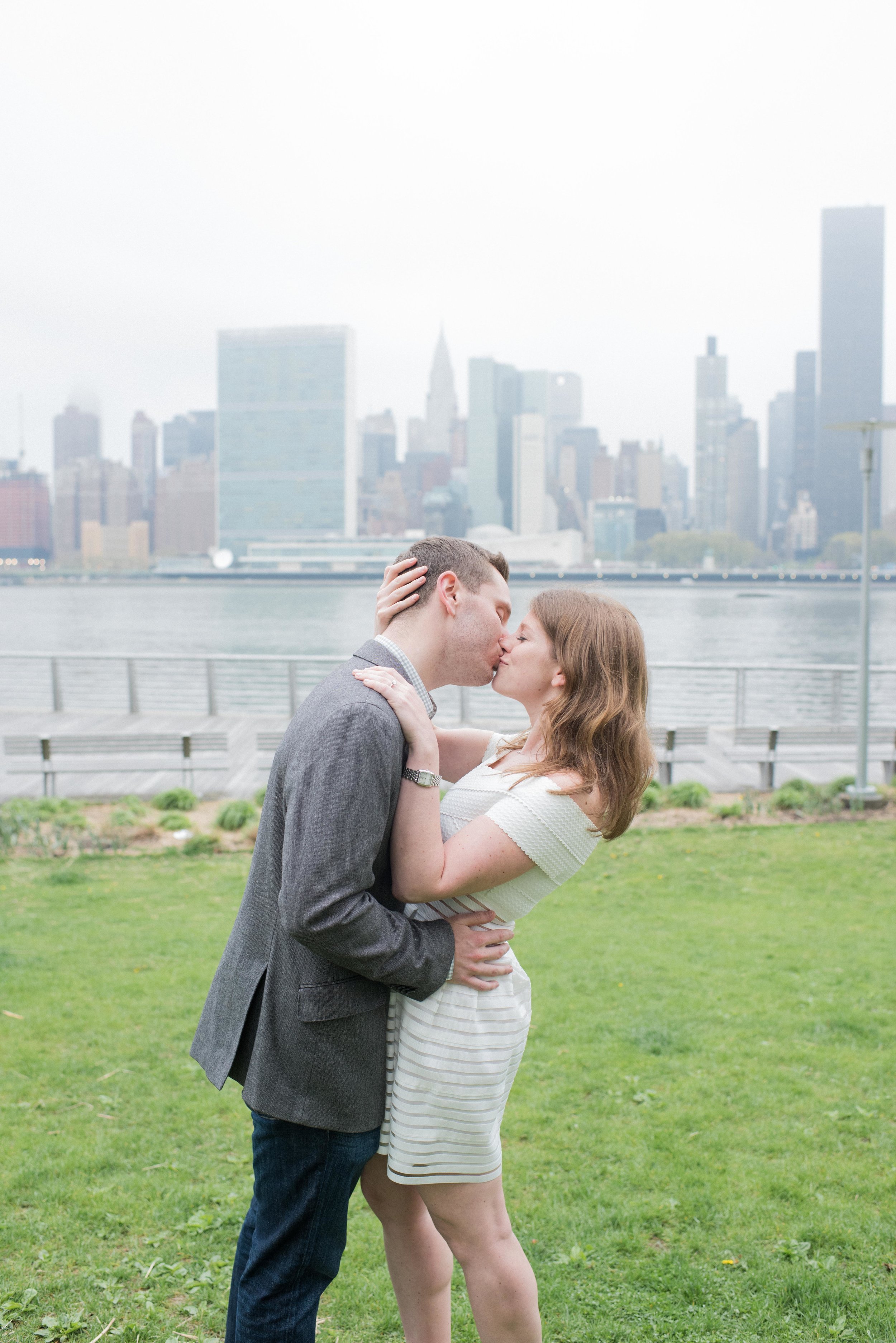 engaged couple in front of manhattan skyline, engaged couple in east river, couple, manhattan skyline, long island city engagement