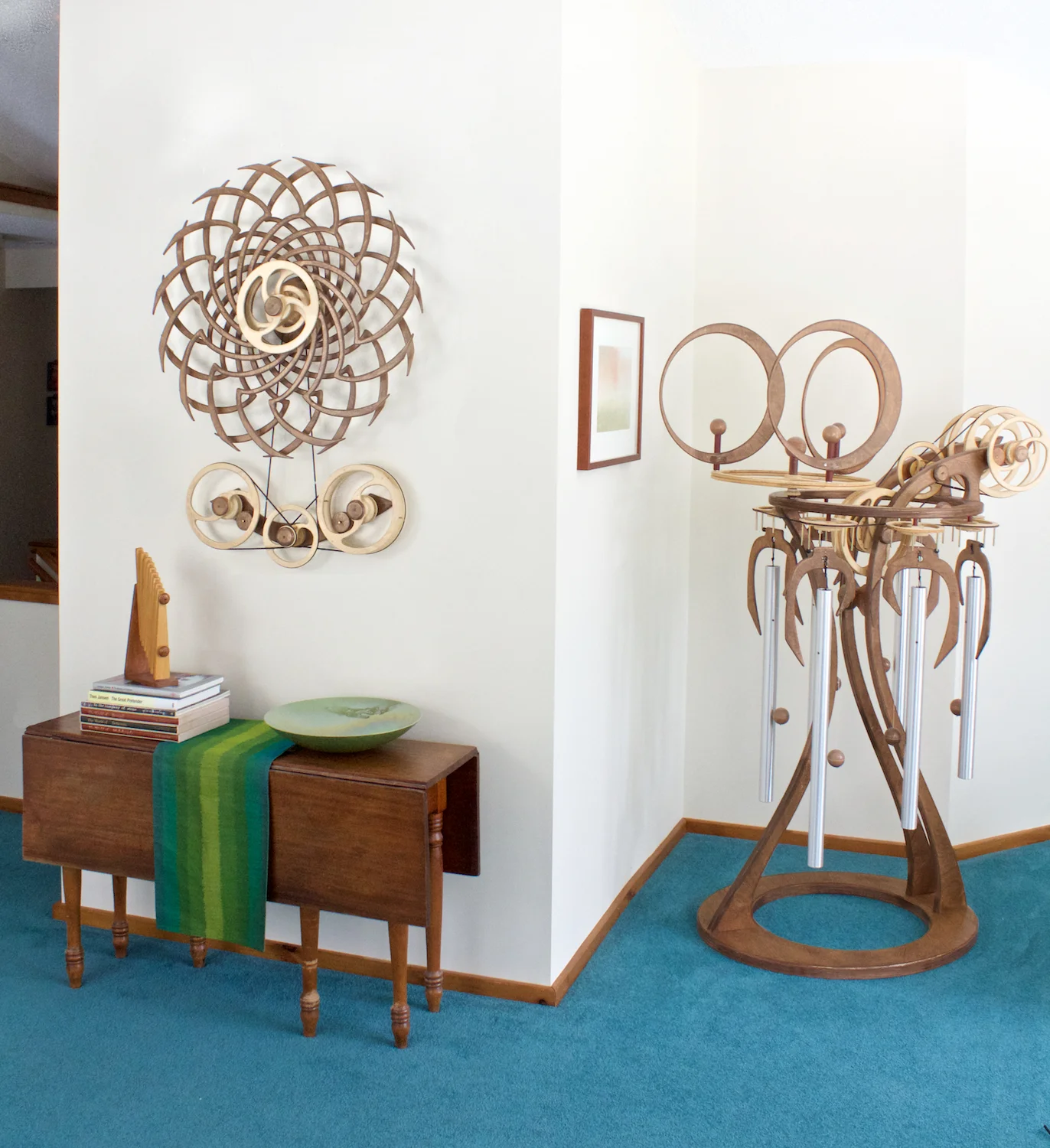 Deja Vu kinetic wall sculpture by David C. Roy in a room setting. Wood That WOrks