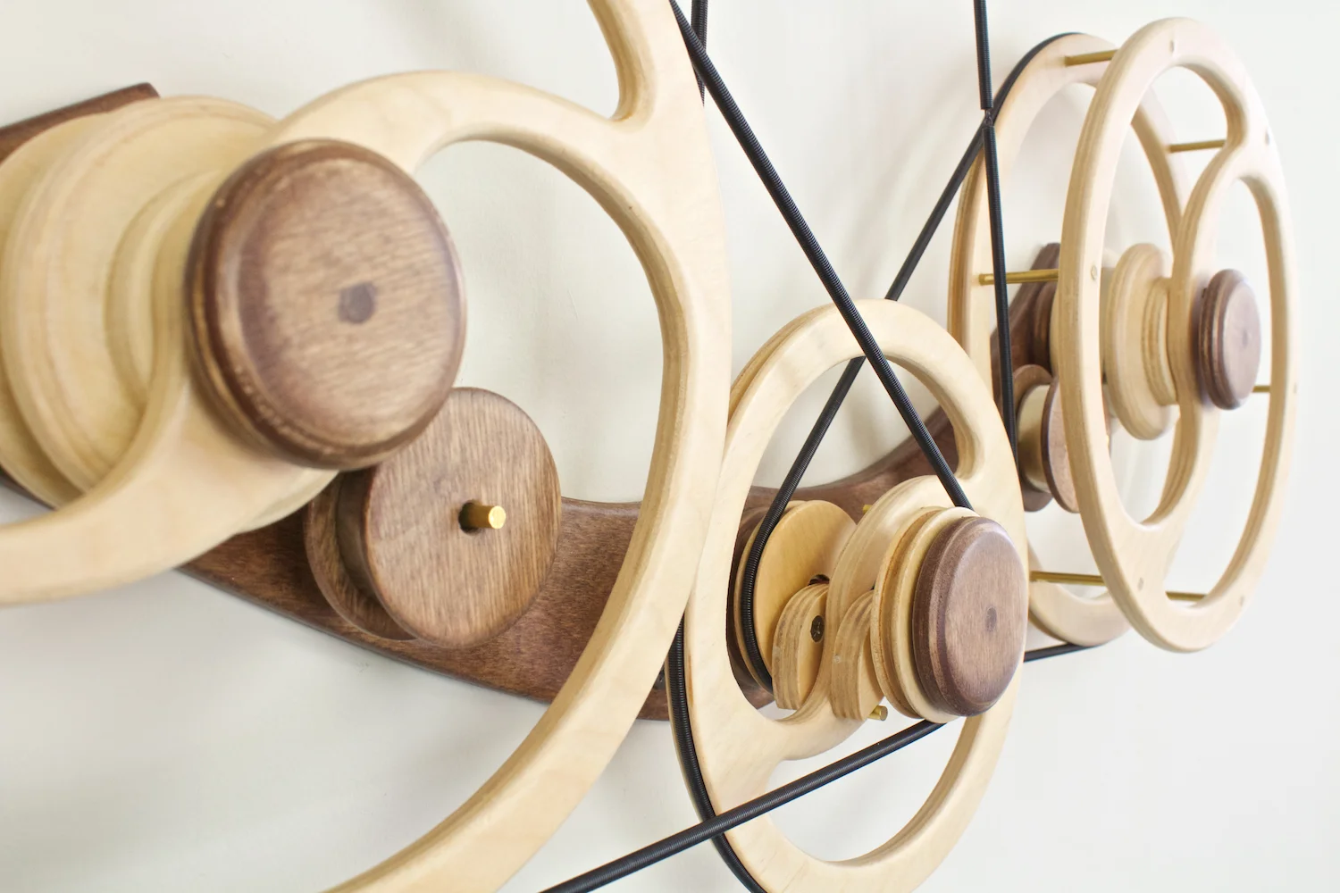 Deja Vu detail view of lower assembly. Kinetic wall sculpture by David C. Roy of Wood That Works