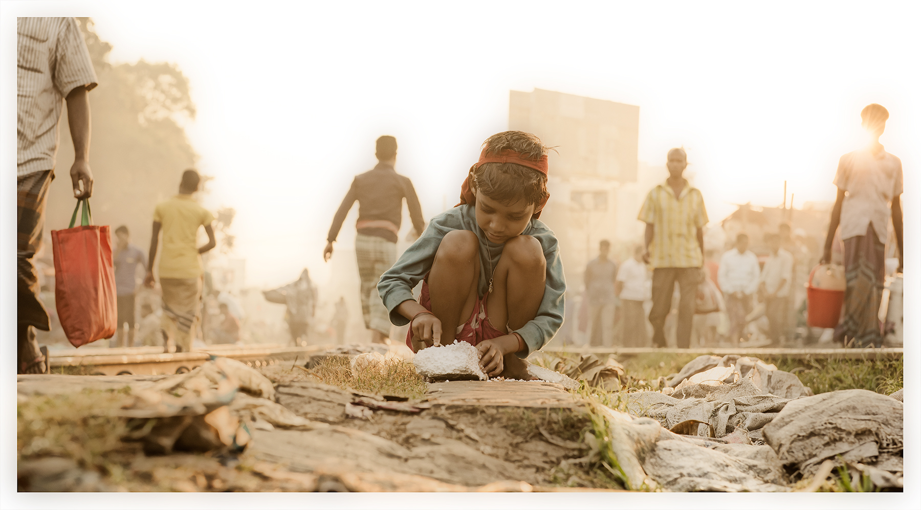 Playing with styrofoam, slum on the tracks, Dhaka, Bangladesh.