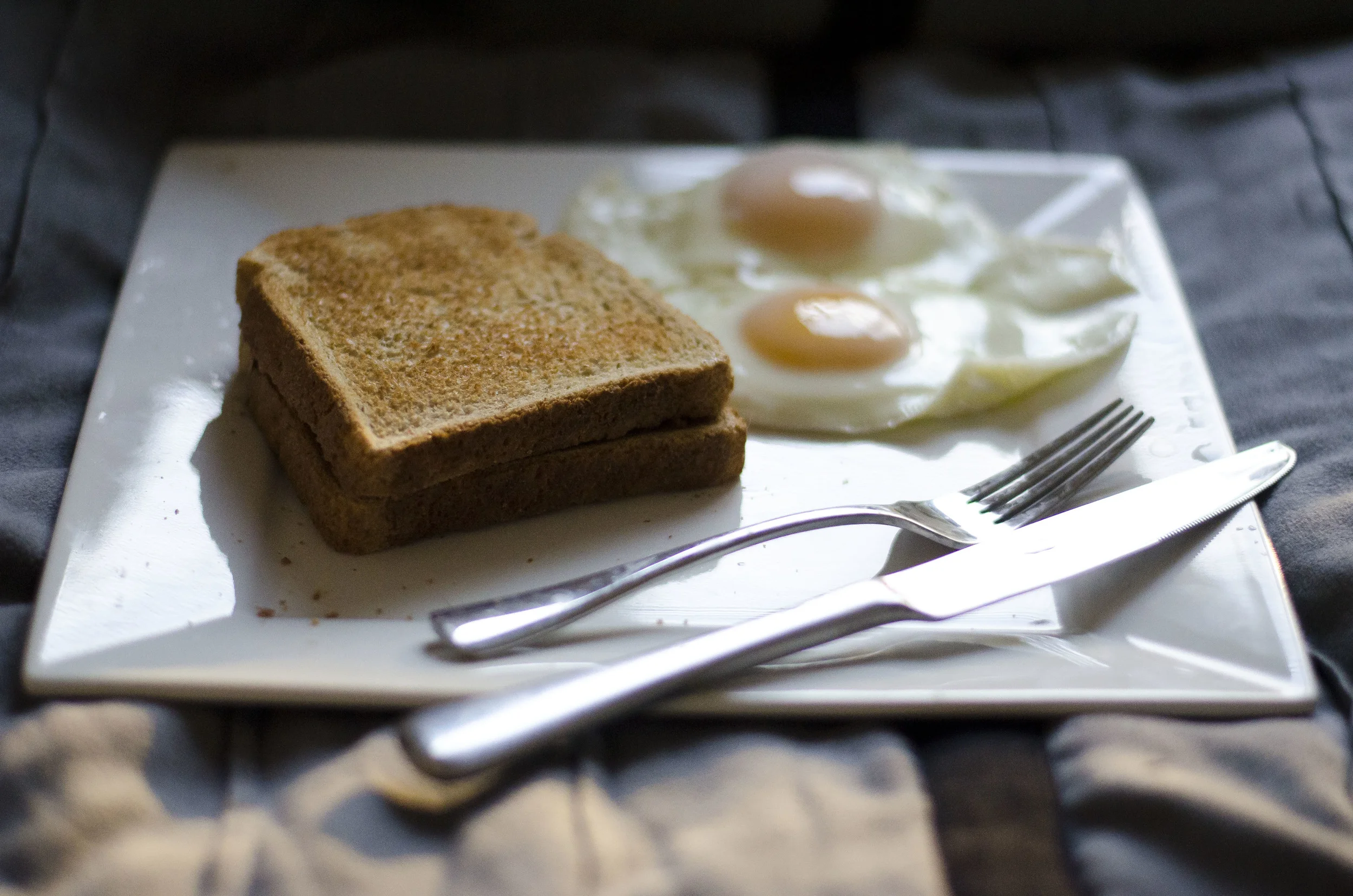 The crackling and sizzling of eggs hitting a hot frying pan, the pop of a toaster. 