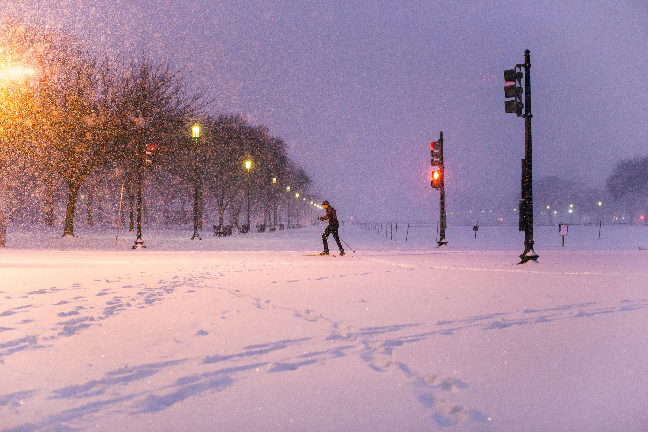  Cross-country skiing across the National Mall. Somewhere in the background, the Washington Memorial is veiled by the snowfall.&nbsp; 