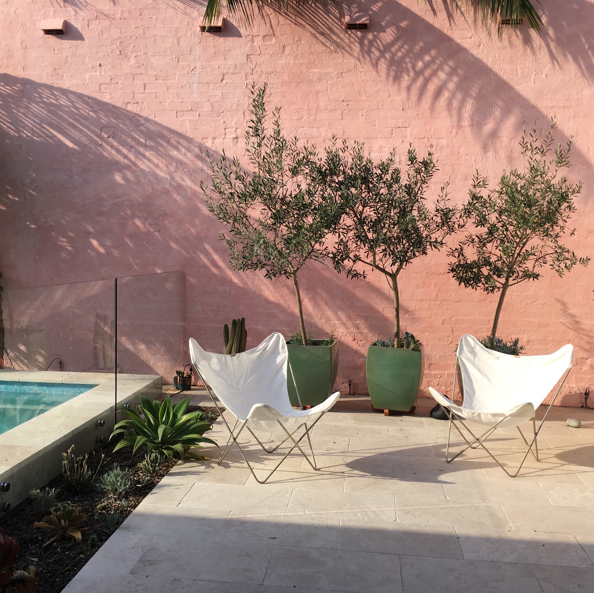 Pool courtyard, the pink wall offers a backdrop to the house drawing you through the spaces. Warm tones are picked up throughout the house from the entry gate, hardwood timbers and in the bathroom tiles.