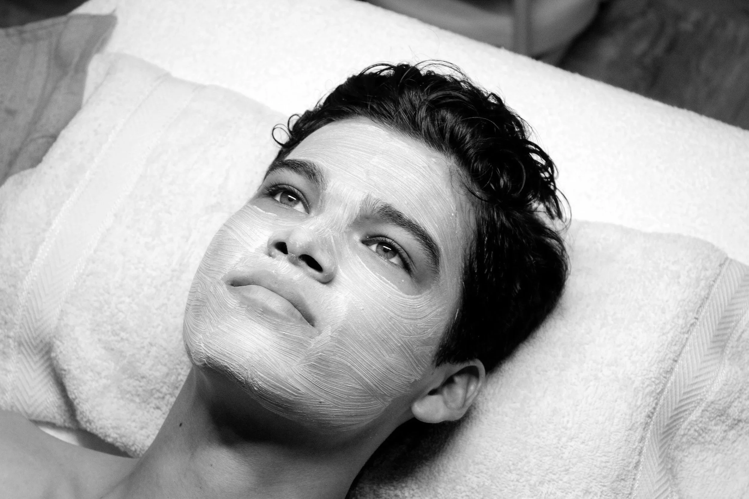 man laying down getting a facial 