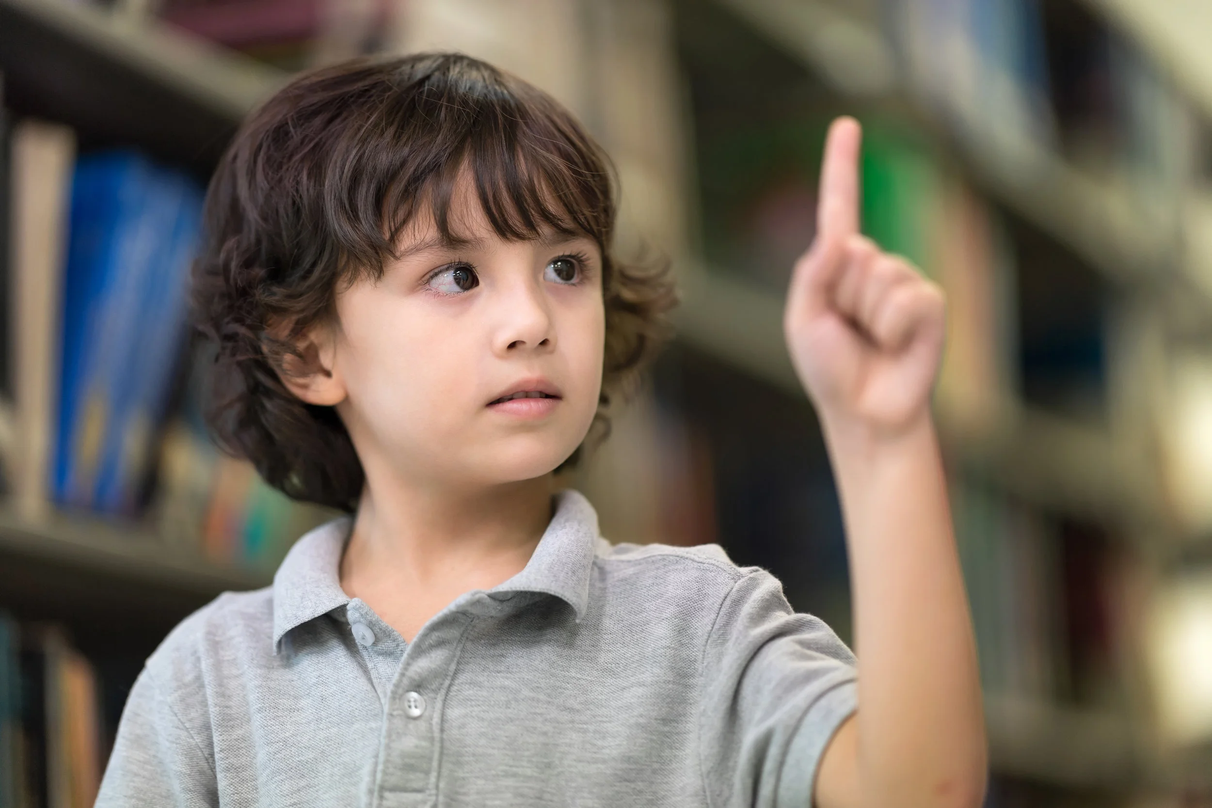 Cute Boy Showing Forefinger as Pressing Screen in the air.