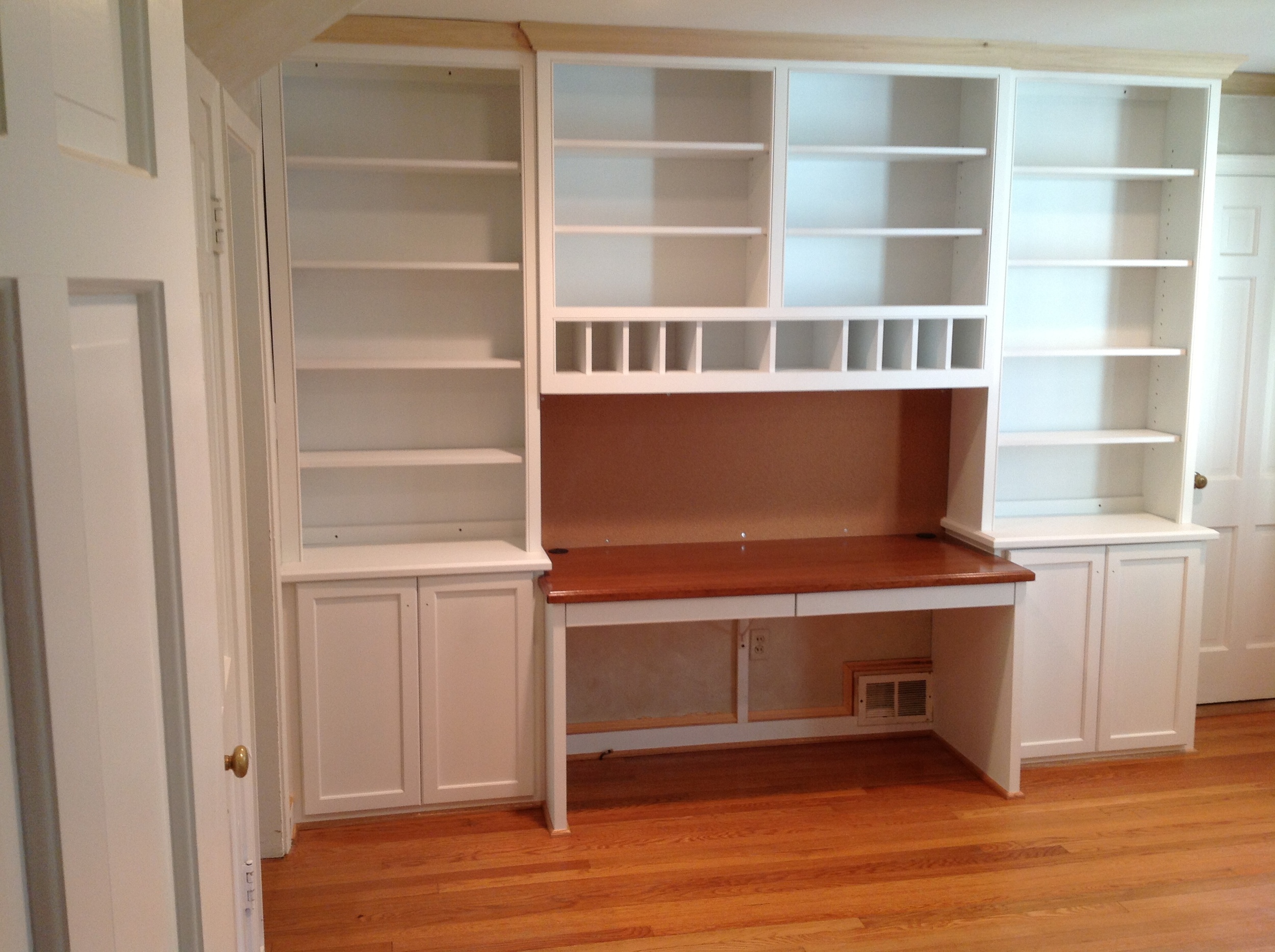 Home office with cherry worktop and pigeon hole storage.