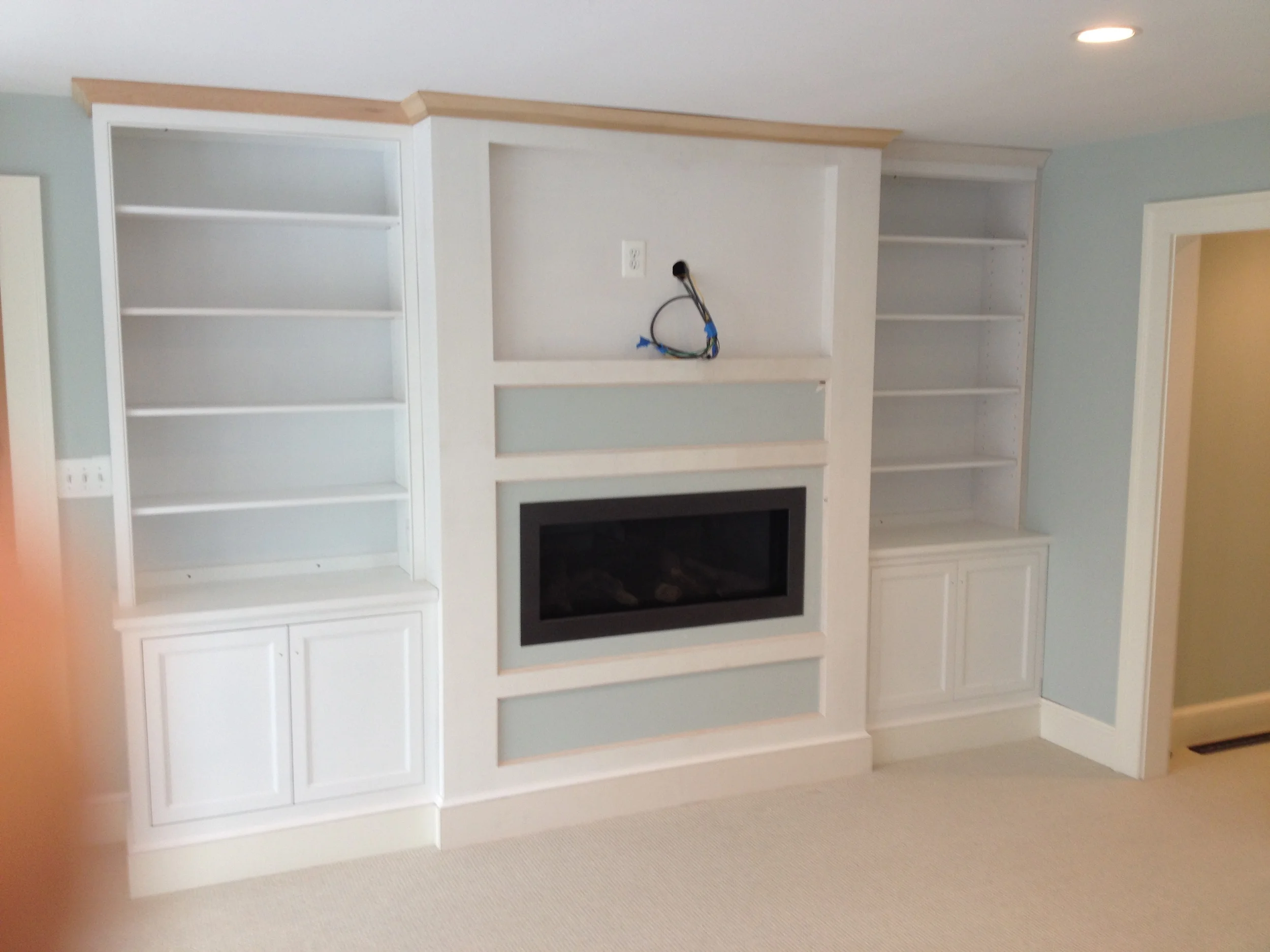 Clean lined cabinetry with recess for television.