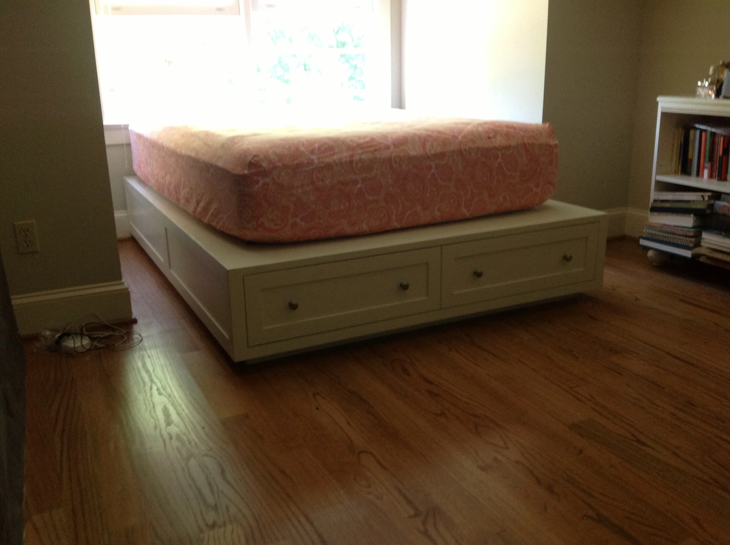 Bed platform with drawers at the end.