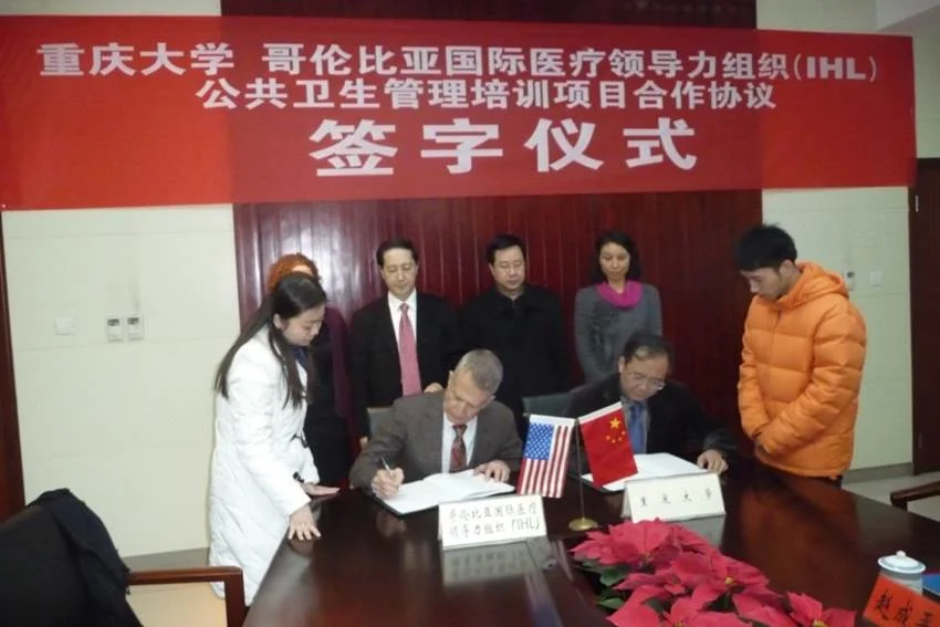 Dr. David P Roye, Jr., signing an MOU with Chongqing University and Columbia University