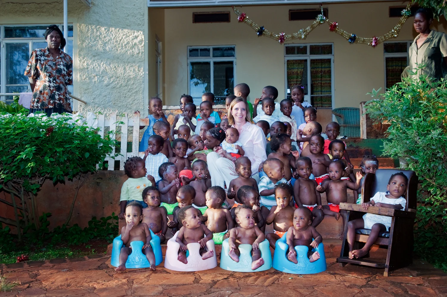 Danyne R Bharj and the children of Amani Baby Cottage in Jinja, Uganda (from Unusual Adoptions).