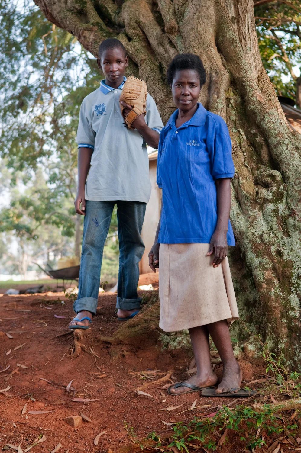 Ivan Matovu and his grandmother Deziranta Namigadde at Kyambogo University sports grounds in Kampala, Uganda (for The New York Times).