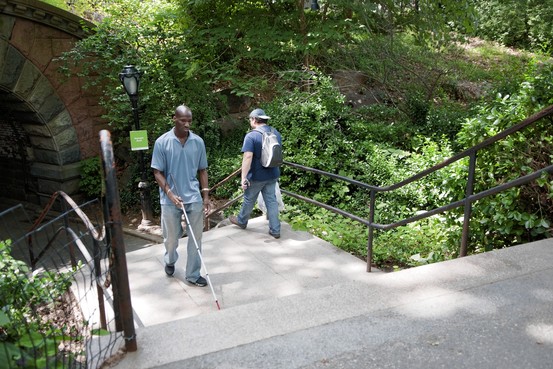 Romeo Edmead walks in Central Park with a help of a cane. 