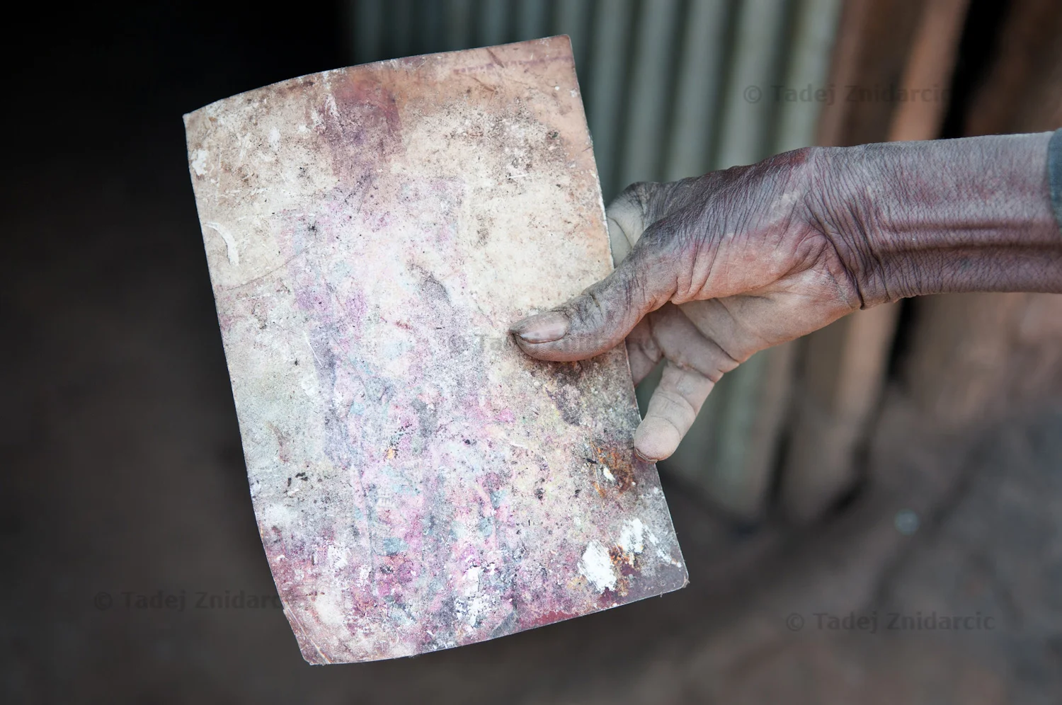 Odora Nakumiya holds the picture of his deceased wife Alwoch Jeroloda.