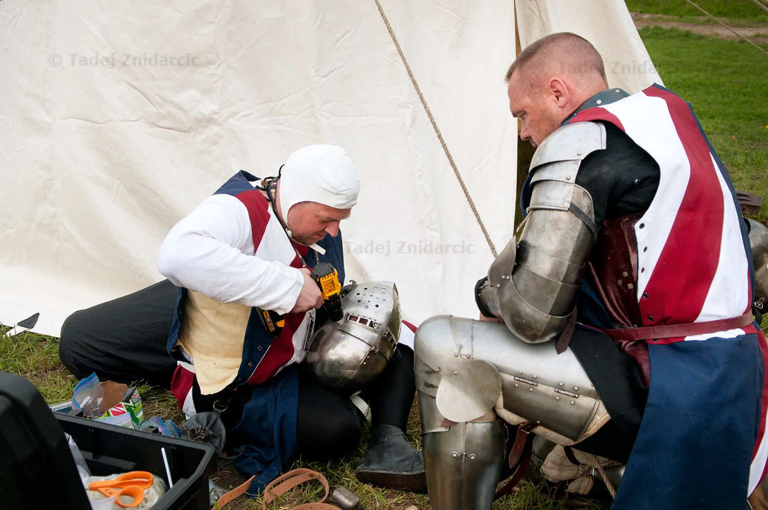Craig Nadler repairs Mark Elrick's helmet during the 2015 IMCF Medieval Combat World Championship at Malbork Castle, Poland.