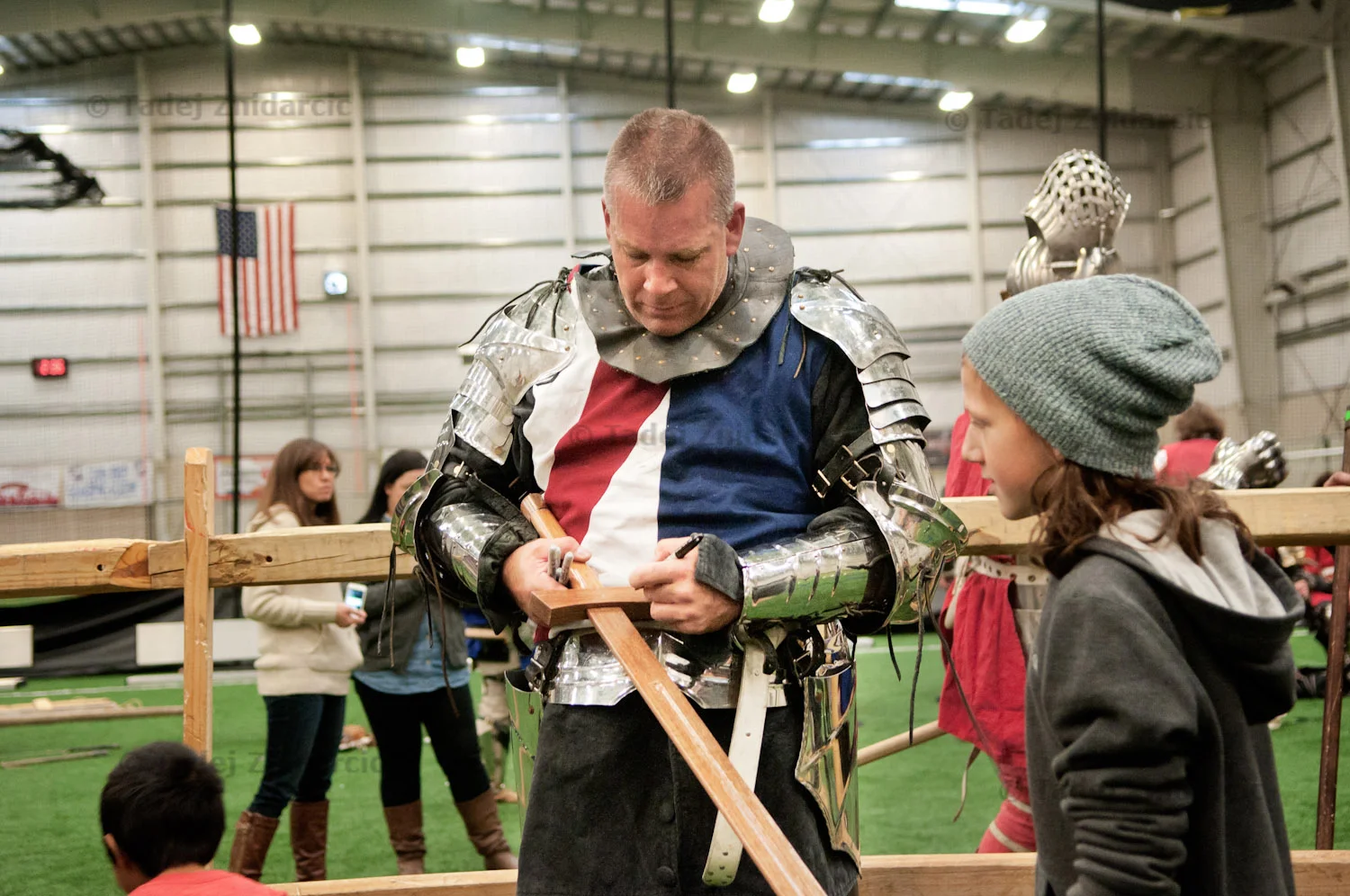 Andre Sinou signs a wooden sword for a fan after the ACL National Qualifiers in Pitman, NJ.