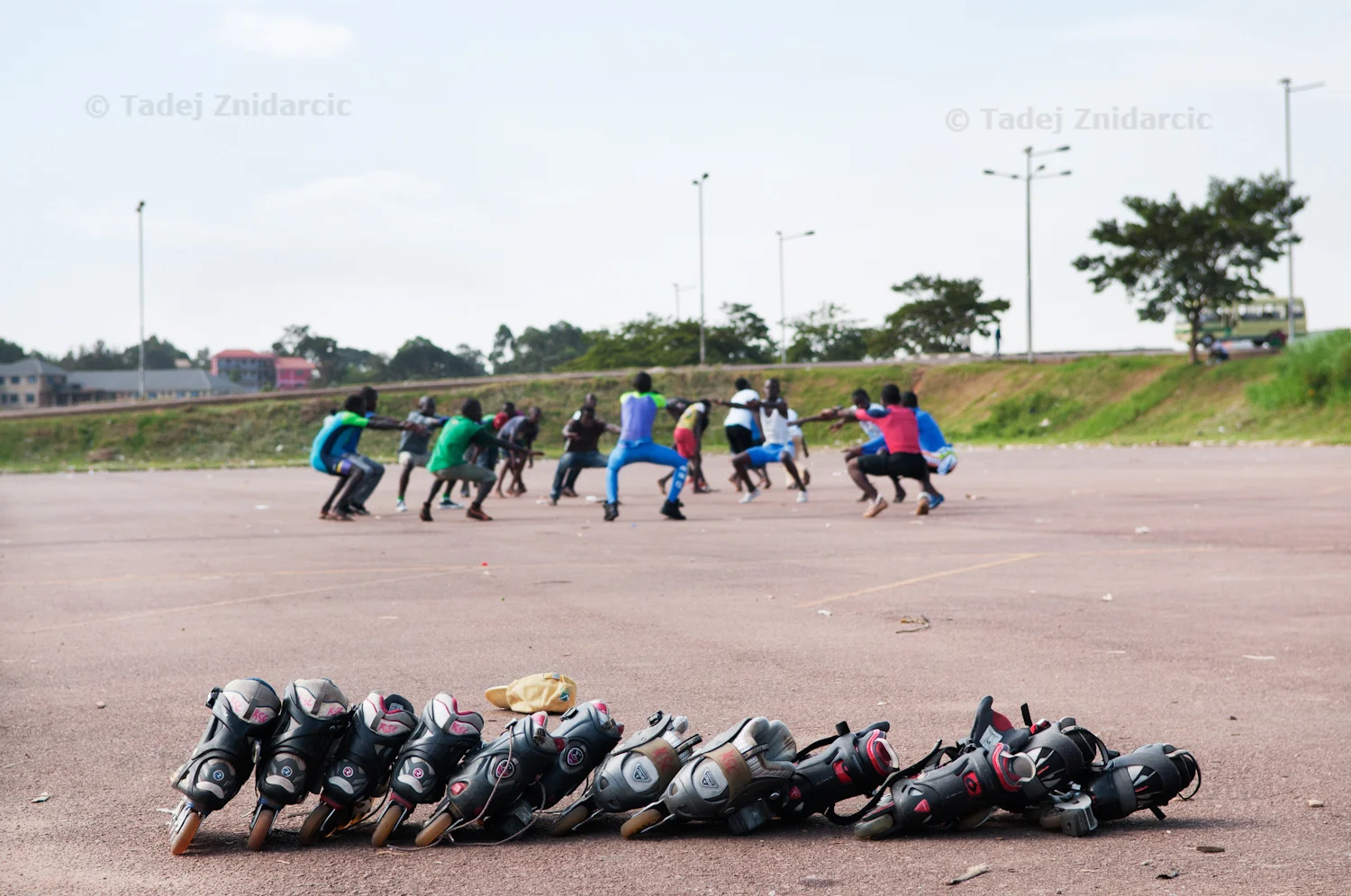 Skaters warm up before the practice at Mandela National Stadium's parking lot in Kampala, Uganda. Every weekend a group of about twenty children and youth gather at the Stadium to practice inline skating.