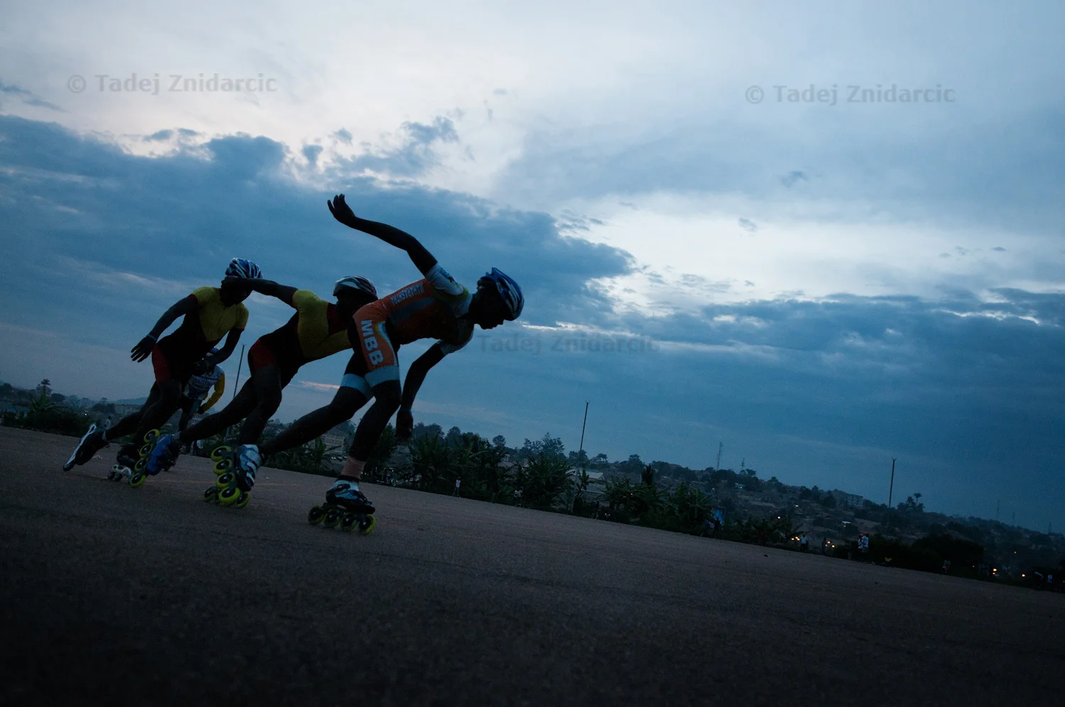 Skaters practice at Mandela National Stadium's parking lot in Kampala, Uganda. The practice starts in late afternoon when the heat is subsiding and lasts past sunset.