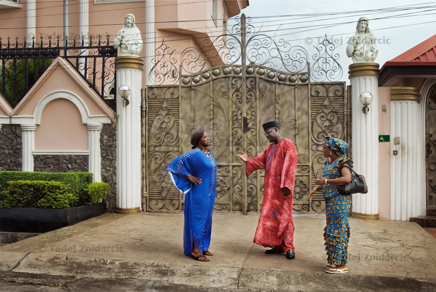 Actors Adaobi Enekwa, Richard Dike and Ngozi Doomanbey (left to right) play members of high society in a scene of a Nollywood movie production. Homes in richer neighborhoods of Lagos are often used for the setting of these movies.