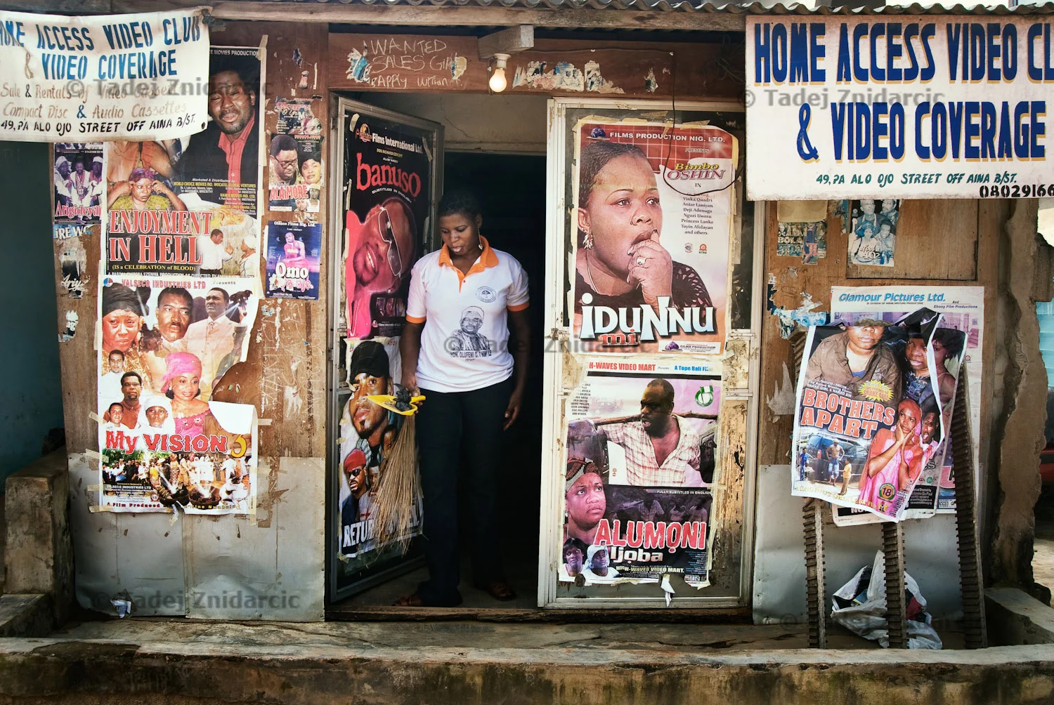 Storekeeper walks out of a local video store that sells and rents Nollywood movies on video cassettes, CDs and DVDs.