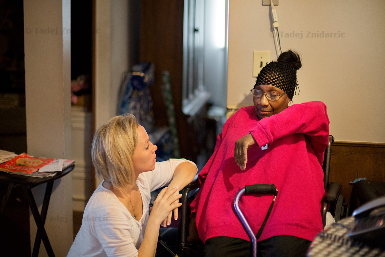 Katy shows occupational therapist Stacy how high she can lift her arm.